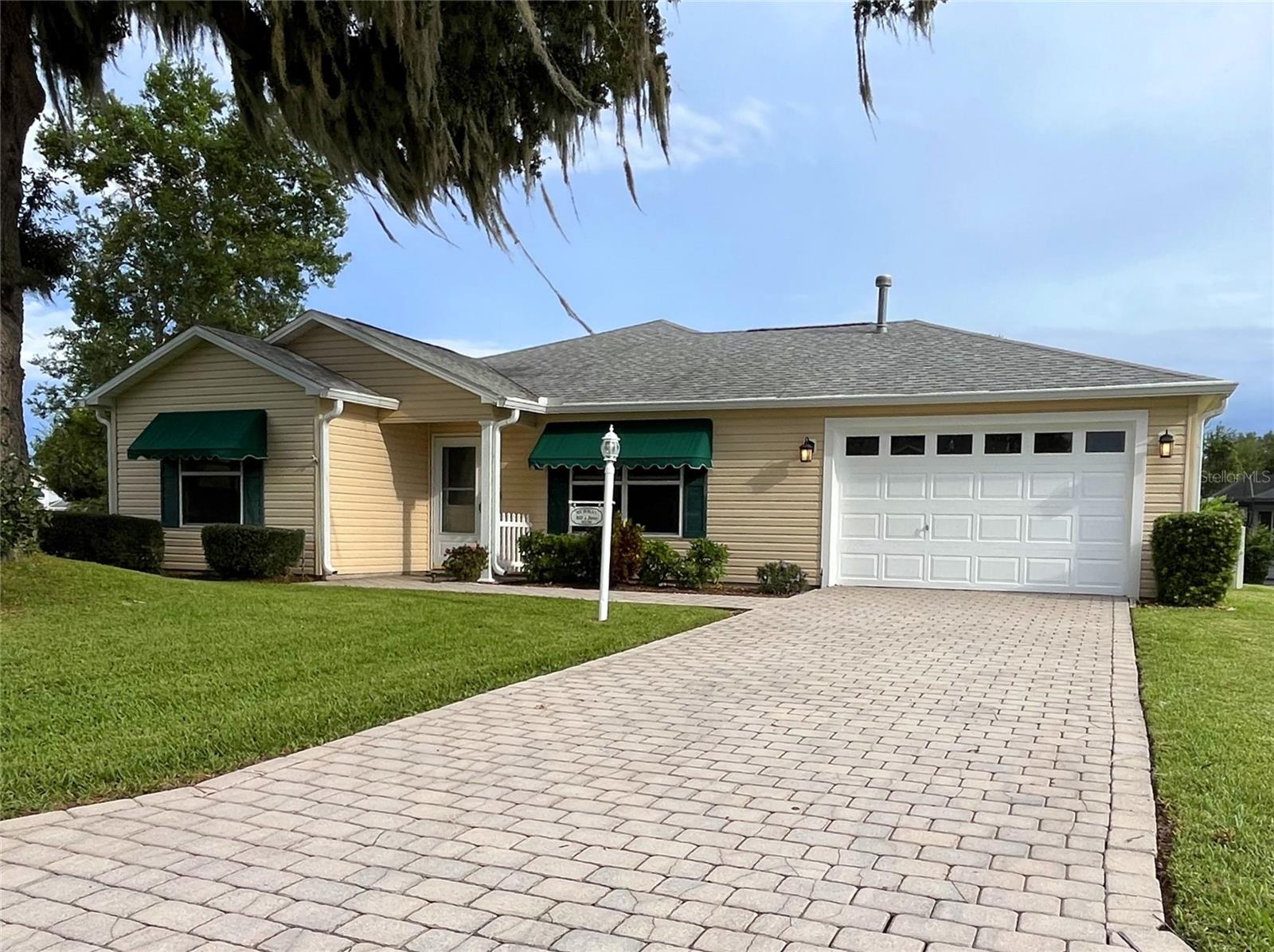 LARGE CORNER LOT with beautiful live oak tree on the front lawn! Same resident since house was built and NO BOND! New roof (2023) with over-sized gutters, new fridge, and freshly painted interior. Nestled in the quaint 55+ community of Springdale, this spacious, 2-bed/2-bath single-level home includes a grand room with open access to a dining area and kitchen with a door to the garage and laundry area. A lanai large enough for another dining table and outdoor entertainment is accessible from the grand room or the main bedroom. The main bedroom has a large closet with a private full bathroom. The guest bath is located between the guest and main bedrooms and includes a tub/shower combo. This is an EXCELLENT location with plenty of elbow room and caring community members! Less than a half a mile to a golf course, dog park, jogging trail, and adult pool! Stores and hospitals are an easy electric golf cart ride away. Make this rare find your next home!