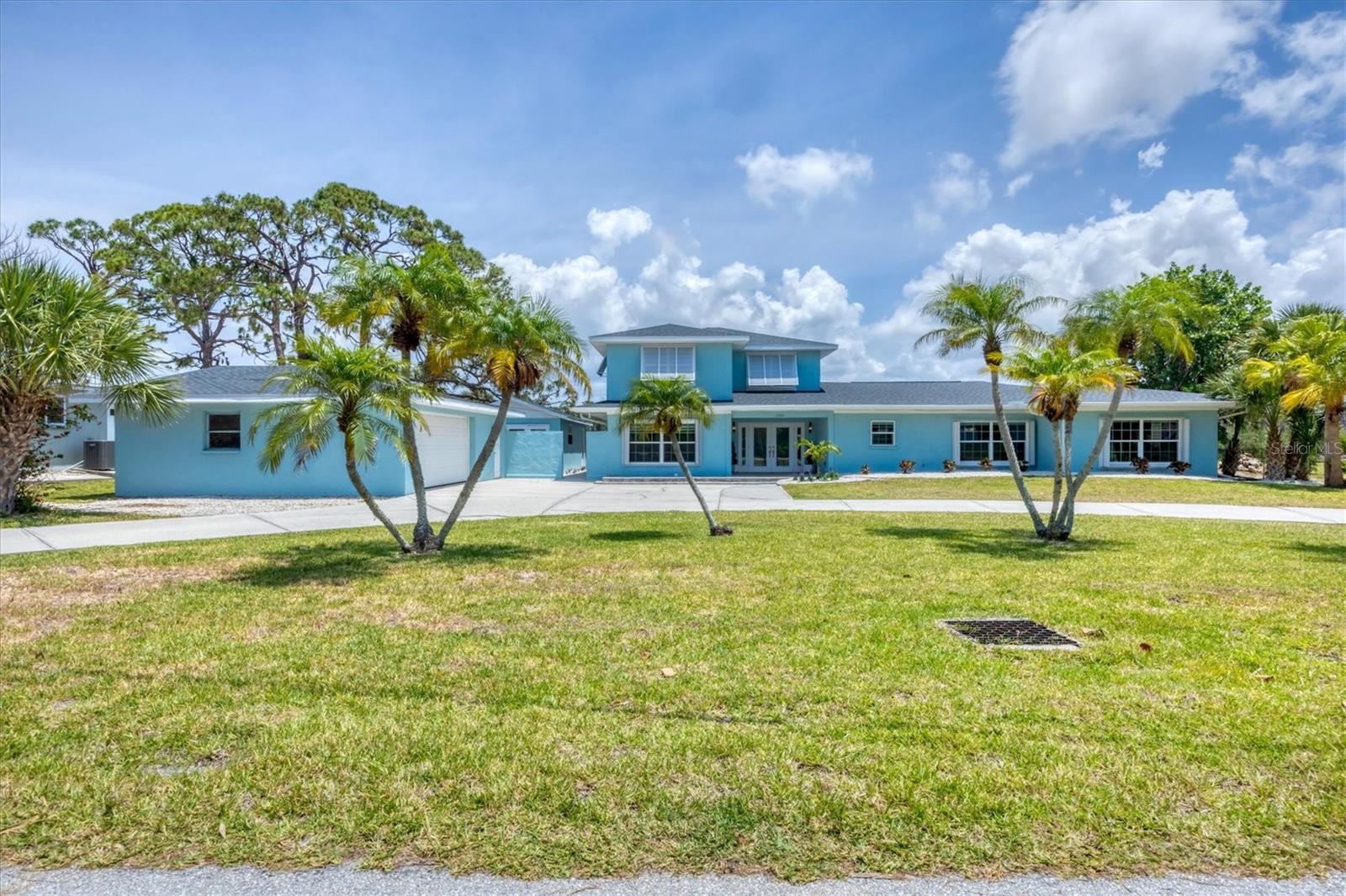 Waterfront oasis on Oyster Creek – nearly 3/4 acre with 2.5 detached garage and separate workshop! This one-of-a-kind property is special. On nearly 3/4 of an acre with stunning views of Oyster Creek and a protected nature preserve, this home offers a blend of privacy, space and waterfront living. Completely renovated in 2016 with thoughtful design and high-end finishes, it seamlessly blends indoor and outdoor living. Step into the dramatic two-story foyer featuring a gorgeous crystal chandelier and an open staircase. The heart of the home is the open-concept kitchen and great room—ideal for entertaining—boasting a wall of sliding glass doors that lead to the expansive lanai with heated and chilled saltwater open-air pool. Water and preserve views can be enjoyed from nearly every room in the house. The primary suite is a tranquil retreat, featuring private pool access, sweeping water views and a spa-inspired bath with a jetted soaking tub, dual sinks and a large walk-in steam shower. A spacious second bedroom is at the front of the home with an updated bath and custom pedestal sink. The third bedroom is oversized and completely private, at the opposite side of the home with its own en-suite bath—ideal for guests or extended stays. Terrazzo flooring flows throughout most of the home for a timeless, low-maintenance finish. Upstairs, a huge loft with built-in wet bar, lounge area and half bath opens to a screened balcony—the ultimate entertaining space with panoramic views of the water and preserve. Need room for hobbies or storage? This home has it all with a 2.5-car detached garage, separate workshop and plenty of room for your imagination. Bring your boat and water toys, you’ll love the Ace boathouse lift and quick Gulf access via Oyster Creek and just one bridge out. Additional highlights include a newer roof, all impact rated windows, circular pull-through driveway for large gatherings, and a long list of thoughtful upgrades throughout. Schedule your private showing today—this is the waterfront lifestyle you've been searching for.