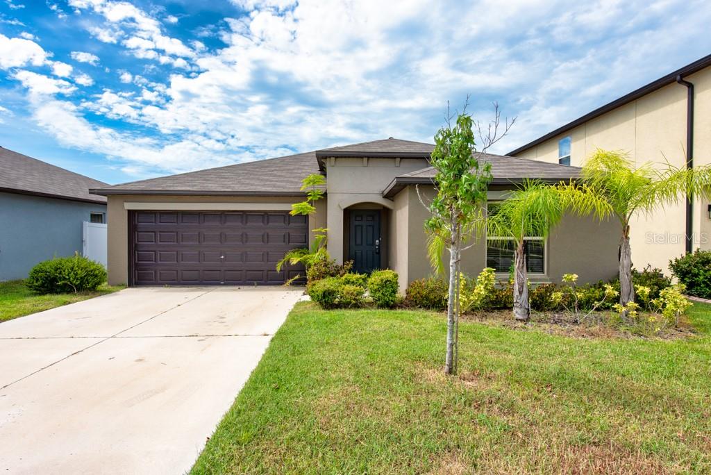 Just 4 Years Young – Stylish Lennar-Built Home with Pond Views! Built in 2021 and lovingly maintained by its original owner, this 4-bedroom, 2-bath beauty offers 1,935 sq. ft. of comfortable living space. A job relocation makes this gem available for its next lucky owner. The open-concept layout features tile flooring throughout the main living areas, with plush carpeting in each bedroom for added warmth and comfort. The modern kitchen is a true centerpiece, boasting granite countertops, stainless steel appliances, a walk-in pantry, and an island with barstool seating overlooking the spacious living room. From the dining area, sliding glass doors open to a relaxing patio with tranquil pond views, framed by white vinyl fencing on each side for added privacy. The split-bedroom design ensures a peaceful retreat in the spacious primary suite, complete with a ceiling fan, ensuite bath with dual sinks, a large walk-in shower, and an expansive walk-in closet. Secondary bedrooms also feature ceiling fans and ample space for family, guests, or a home office. Additional highlights include a tankless water heater, energy-efficient design, and a prime location near Hwy 301 and Big Bend Rd—just minutes from shopping, parks, schools, restaurants, and with quick access to I-75 for an easy commute. This home blends modern comfort, thoughtful design, and a serene setting—ready for you to move in and enjoy.