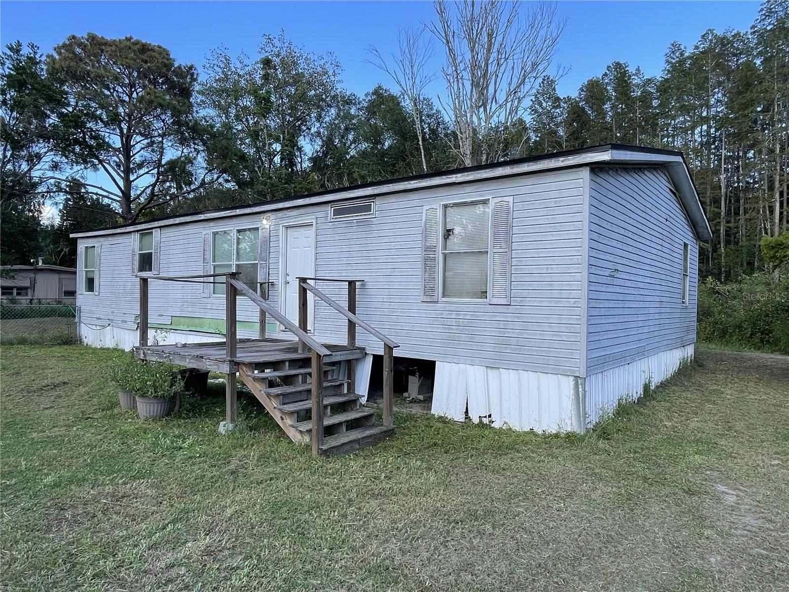 **PRICE REDUCED** 1/2 ACRE OF PRIME BUILDABLE LAND IN THE HEART OF LAND O LAKES OR A HANDYMAN'S DREAM REMODEL! Existing mobile home is a 3 bed 2 bath double wide with a new roof. It is a great space, but needs some TLC. Alternatively, the oversized half acre water front lot is situated at the end of a quiet street (only 1 neighbor!!) and offers the perfect palette to build your dream home! Call today to schedule a showinbg!