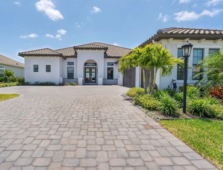 Exemplifying luxury at its finest, this opulent, deeded golf home on a spacious ninety-foot lot occupies a coveted location on the 13th hole of the esteemed Esplanade at Azario golf course in Lakewood Ranch. As you enter through the glass double front doors, your gaze is instantly captivated by the serene water views and the sprawling golf course, seamlessly framed by the expansive, panoramic pool screen. As you enter the foyer, the elevated ceilings not only create a visually stunning effect, but also provide an airy and spacious feel, setting the tone for the rest of this exquisite home. To the left of the foyer, a versatile office space awaits, offering the potential to effortlessly transform into a fourth bedroom if desired. This multi-functional room is equipped with a convenient Murphy bed system, complete with closet and drawers, providing ample storage space while maintaining practicality. The sunlit dining area flows effortlessly into the great room, creating an open atmosphere for entertaining. Stepping into the great room, your eyes are immediately drawn to the breathtaking feature wall. This stunning focal point is adorned with custom built-ins, floating shelves, and a gorgeous fireplace, exuding elegance and warmth on chilly evenings. Open to the great room, the kitchen seamlessly integrates with the living space creating a central area for gathering. The kitchen features GE monogram appliances, including a built-in refrigerator, Cafe double wall oven, gas cooktop, wine refrigerator, and an upgraded stainless steel monogram hood. At the heart of the kitchen is a huge island with striking quartz countertops and wrap around cabinetry, offering plenty of storage. Under cabinet lighting and a designer stainless steel apron sink finish the space. Adjacent to the kitchen, a perfect breakfast nook offers serene views of the water and golf course. At the opposite side of the home, you’ll find the luxurious owner’s retreat. Carrara tile is laid throughout the entire suite creating a luxurious backdrop. The owner’s bath features a glass enclosed shower and a freestanding soaker tub ideal for a spa like experience. Two additional guest bedrooms each with walk-in closets provide a comfortable space for guests. Whether it’s the well designed laundry room with ample cabinetry, or the 3 car garage, this home ensures that all your storage needs are met with style. Towards the back of the home, a large bonus room awaits, offering a versatile space perfect for movie nights or just unwinding with friends and family. A walk out slider provides easy access to the impressive lanai. The lanai in this home truly embodies the essence of Florida living. Whether it's lounging in the shade of the covered outdoor areas, relaxing in the saltwater pool and spa, dining al fresco, or practicing on your own putting green, this lanai provides the perfect setting for enjoying the Florida lifestyle. Esplanade at Azario features amenities like no other. A full-service spa, Bahama bar, resort pools, fitness center, coffee shop, 18 hole golf course, and sports courts are all within your own neighborhood. The culinary center will offer world class culinary experiences from fine dining, cooking classes, wine tastings, and more. “A” rated schools, miles of trails, world class shopping and dining, and the gulf coast beaches are all at your fingertips.