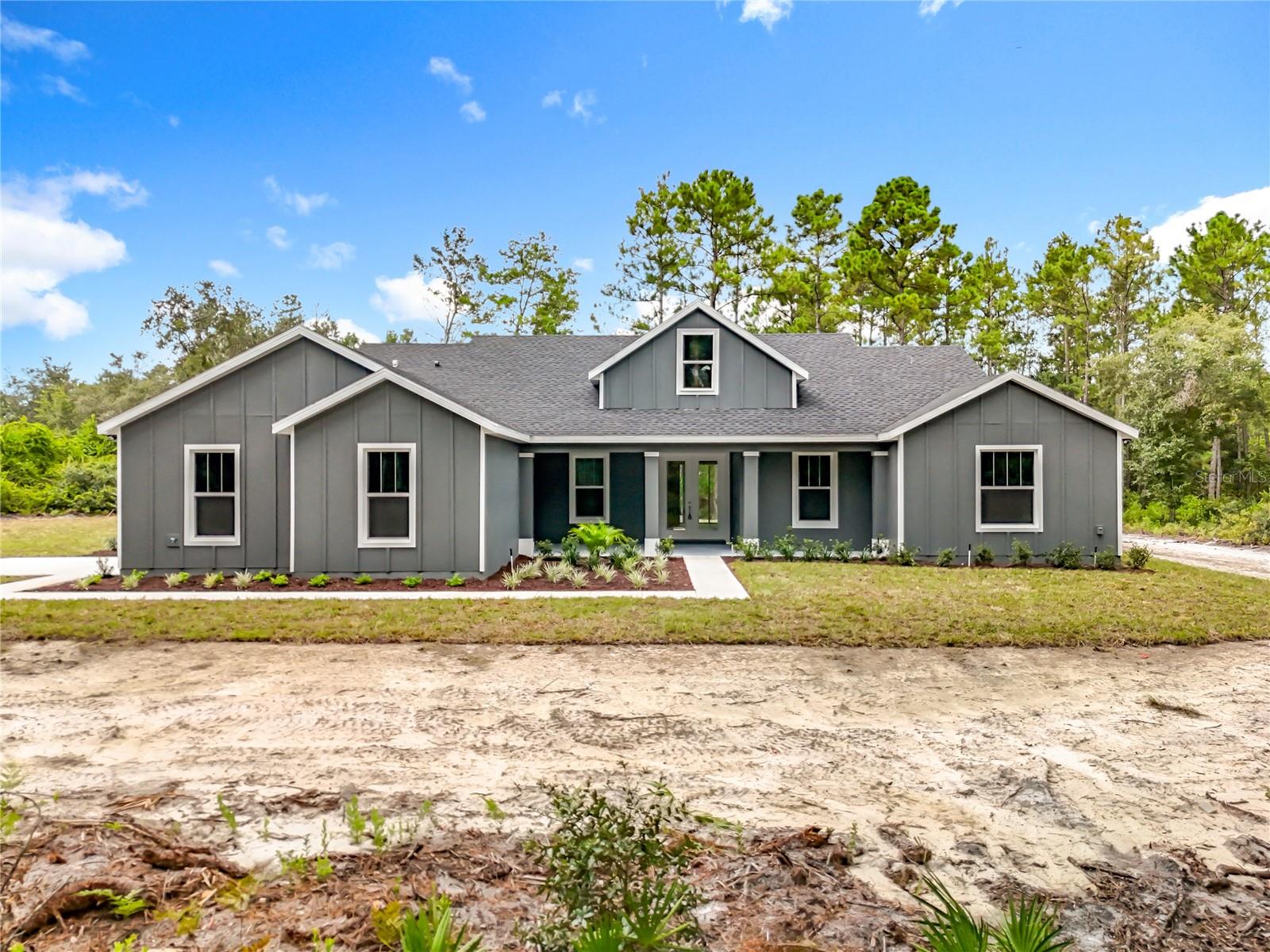 Custom-Built Luxury on a one-acre private lot!
Experience refined country living in this custom-built luxury home, nestled on a serene 1-acre homesite offering privacy, peace and space to breathe. From the moment you arrive, the expansive front porch welcomes you with charm, featuring French doors that open into a stunning great room with the perfect blend of comfort and elegance.
Designed for the chef at heart, the gourmet kitchen boasts a large center island, beautiful finishes, and a seamless flow ideal for entertaining. A three-panel sliding door fully opens to an expansive back lanai complete with a full outdoor kitchen perfect for gatherings or quiet evenings under the stars. There's also a convenient half bath with outdoor access, making this home pool-ready!
Inside, you’ll find 4 spacious bedrooms, 2.5 bathrooms, and a luxurious master suite with a spa-inspired bathroom that’s sure to impress. The garage features epoxy-coated floors for a clean, polished look.
This home is the perfect blend of upscale living and relaxed country charm, come and see today!