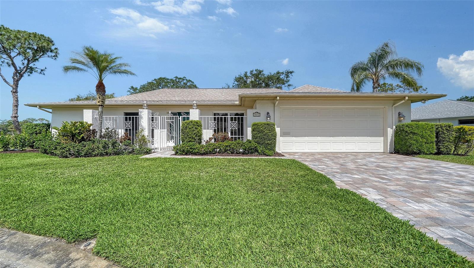 Serene, spacious and private with golf course views! This three-bedroom plus office pool home offers ideal Florida living with no neighbors in sight in The Meadows, a tranquil 1,600-acre park-like oasis in a thriving Sarasota location. Tucked on a cul-de-sac, a private third of an acre, paver driveway and gated front patio welcome you home. Inside, you’ll love the thoughtful split layout designed for space and privacy, while pocketing sliders seamlessly blend indoor and outdoor living. A stunning kitchen features gleaming Imperial Almond Brazilian granite countertops, solid hickory cabinetry and stainless-steel appliances. The expansive lanai is an entertainer’s dream, with a covered lounging area, pass-through window to the kitchen, and a heated pool and spa adorned by long, relaxing golf course views. The primary suite and office enjoy their wing, while a separate wing features the family room, two guest bedrooms and baths, offering total flexibility and privacy. All half a mile to all fun the Meadows has to offer, moments from the best of Sarasota, yet wrapped in the peaceful beauty of nature. The Meadows, 1,600 park-like acres in an enviable location, is a resort lifestyle community 15 minutes from downtown. Residents enjoy 14 miles of trails, fun activities, fitness center, Junior Olympic pool, 10 pickleball courts, dining venues plus pay-to-play three 18-hole golf courses and a top-notch tennis complex. You’ll live near award-winning beaches, remarkable arts and culture, Nathan Benderson Park, Mote SEA Aquarium, Whole Foods, Trader Joe’s and The Mall at University Town Center, a world-class shopping, entertainment and dining destination. A fabulous Florida lifestyle awaits. 2024 shingle roof, 2014 air-conditioning system, irrigation well, pool and spa heaters, central vac, and above flood plain in zone X.
