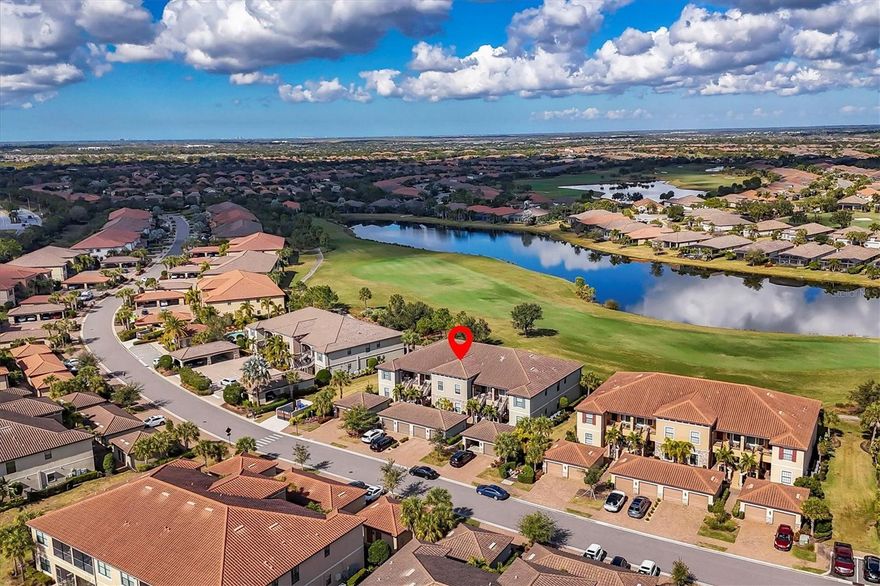 TURNKEY FURNISHED WITH DEEDED GOLF MEMBERSHIP AND STELLAR VIEWS! This tastefully decorated, well-maintained second-floor two-bedroom plus den, two-bath condo with vaulted ceilings and a one-car garage in Esplanade Golf and Country Club of Lakewood Ranch is move-in ready. Just bring your clubs and suitcase! The well-appointed kitchen features tall wood cabinetry, stainless steel appliances, granite countertops, upgraded faucets and fans, and an eating area up front. The spacious open floor plan includes a dining room/great room combination and a den, all with sensational lake and golf course views. Triple sliders lead to your screened-in covered lanai with one of the most magnificent views in the community. The primary suite shares this stunning view and includes a king-sized bed, ensuite bath with dual sinks, granite countertops, wood cabinetry, separate shower stall, private commode, and two large walk-in closets. The guest room is split from the primary for privacy and located near the second full bath with a tub/shower combo and matching finishes. Laundry/utility room has a newer washer and dryer. Esplanade is one of the most amenity-rich established communities in Lakewood Ranch, offering a resort lifestyle that rivals top vacation destinations. The community blends Tuscan-inspired architecture with lush landscaping and sweeping golf vistas. Enjoy world-class golf on a championship course that hosts tournaments throughout the year, with top-tier practice facilities designed for serious play and casual enjoyment alike. This active lifestyle community offers a lagoon-style heated pool and spa with cabanas, several tropical satellite pools (one just steps away), two 24-hour gyms, group fitness classes, personal training, full service spa, lit tennis courts, pickleball, bocce ball, dog parks, Bahama-style poolside tiki bar, and full-service dining at the Barrel House Bistro. The full-time Lifestyle Director coordinates standout events, including live music, wine dinners, trivia nights, and seasonal celebrations. Resident-led groups include weekly golf outings, poker nights, and ladies' luncheons. Check the community calendar, there's always something happening! Lakewood Ranch is an award-winning master-planned community with glorious weather, top-rated schools, and a perfect inland location. Enjoy proximity to world-renowned beaches (Siesta Key, Lido, Longboat, and Anna Maria), boating, fishing, biking, walking trails, UTC Mall, and countless restaurants. Downtown Sarasota and Bradenton offer vibrant dining, rooftop bars, arts, and cultural venues. Multiple international airports within an hour. Welcome to the Gulf Coast lifestyle!