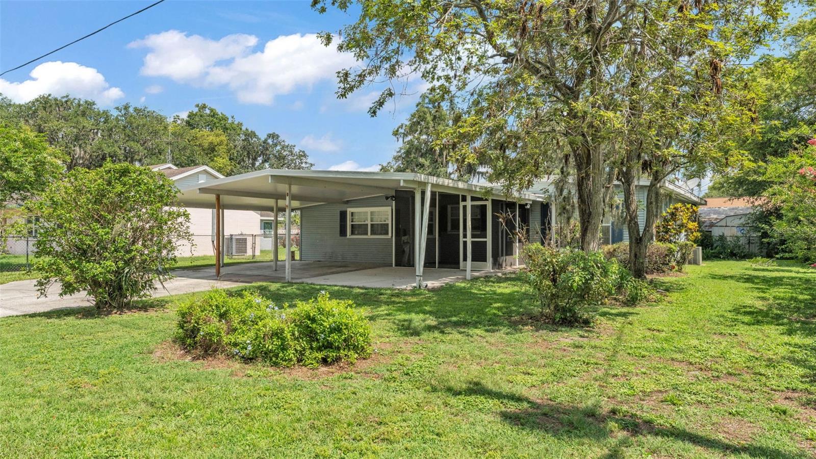 Ideal opportunity to own your own home! This three-bedroom, one-bath home is situated on a spacious fenced lot with a large backyard. Enjoy evenings on the screened front lanai.
Upon entering, you'll find an open living room and dining area that lead into the galley kitchen. Additionally, there's a large family room off the dining room. From there, you can access an oversized enclosed porch, perfect for conversion into a game room or man cave. In Ashton the fenced backyard you have a large shed for storing your toys and lawn equipment. Don't miss this chance to make it your own!