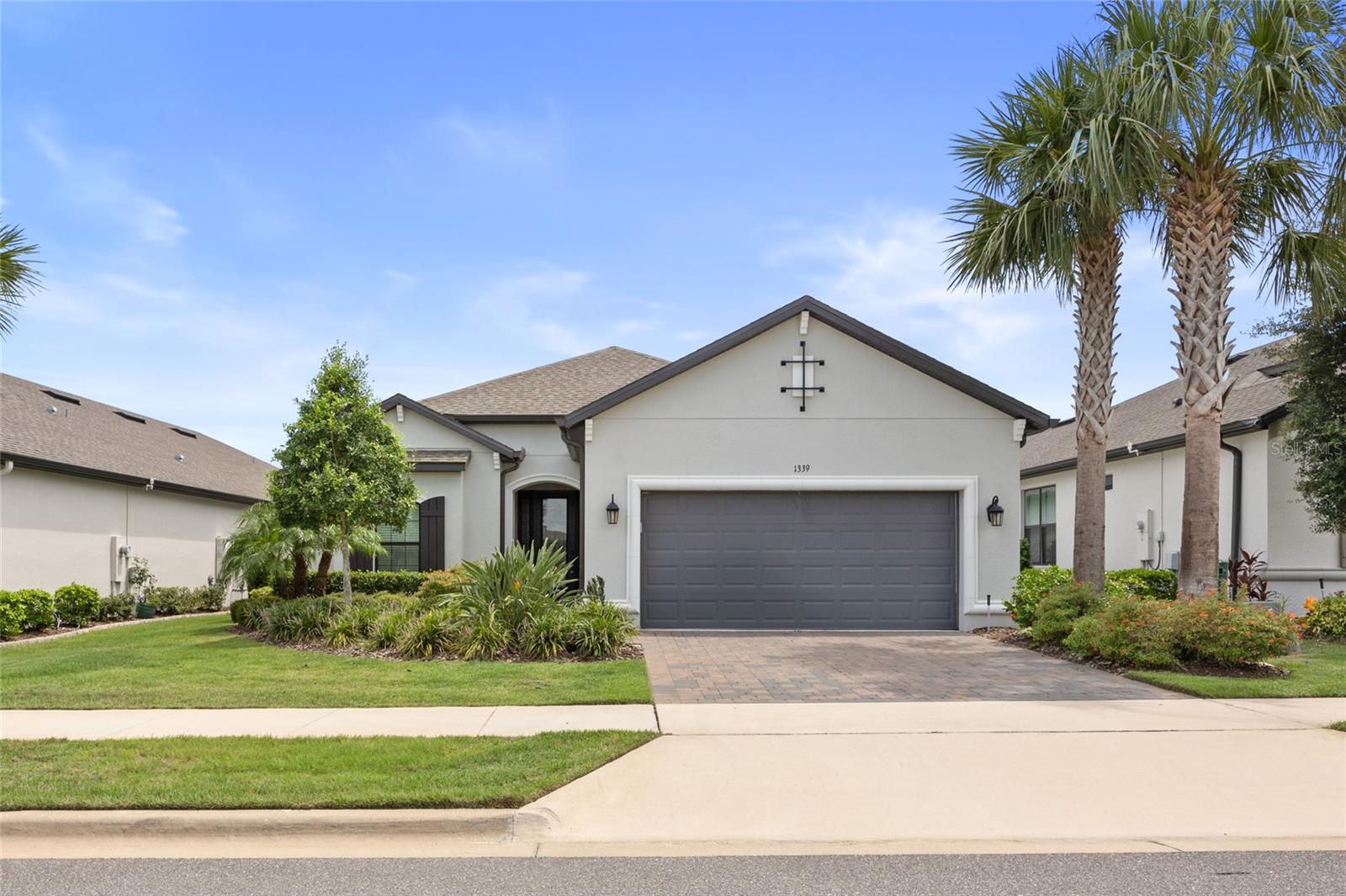 Welcome to the Esplanade at Highland Ranch – Clermont’s Premier 55+ Resort-Style Community!
Step into this stunning 3-bedroom, 3-bath, 2,449 sq ft one-story home nestled in the beautiful rolling hills of Clermont. This residence boasts an open floor plan with generous room sizes, tile flooring throughout, and plush carpet in the bedrooms.
From the inviting large foyer, enter the bright living area featuring a tray ceiling, crown molding, and full glass sliding doors that fill the space with natural light. The spacious primary suite offers a tray ceiling, bay window seating area, and a luxurious en-suite with a large walk-in shower, double sink vanity, private water closet, and an oversized walk-in closet.
Bedroom 2 features its own private en-suite, ideal for guests, while Bedroom 3 is conveniently located near the third full bath.
You’ll love the gourmet kitchen equipped with stainless steel appliances including a double oven, elegant countertops and backsplash, soft-close solid wood cabinetry, a walk-in pantry, and a dual-container trash bin. There’s also an office/flex room with French doors, and an inside laundry room with ample cabinet space, sink, washer, and dryer.
Enjoy Florida living on the spacious screened lanai, and take advantage of the oversized garage for all your storage needs.
The HOA covers lawn and shrub care, fertilizing, mulching, irrigation maintenance, amenities, gates, and roads. Residents enjoy an impressive lineup of resort-style amenities, including heated pools (lap and resistance), spa, tennis, bocce ball, pickleball (all lighted for evening play), fire pit, billiards, table tennis, card room, movement studio, outdoor kitchen, dog park, and a variety of clubs and social activities.
Perfectly located near hospitals, medical facilities, shopping, dining, golf, Disney attractions, NTC, and miles of biking/walking trails, with easy access to the Florida Turnpike and only 35 minutes to Orlando International Airport.
No CDD fees. Don’t miss the chance to own this spectacular home in one of Clermont’s most desirable communities!