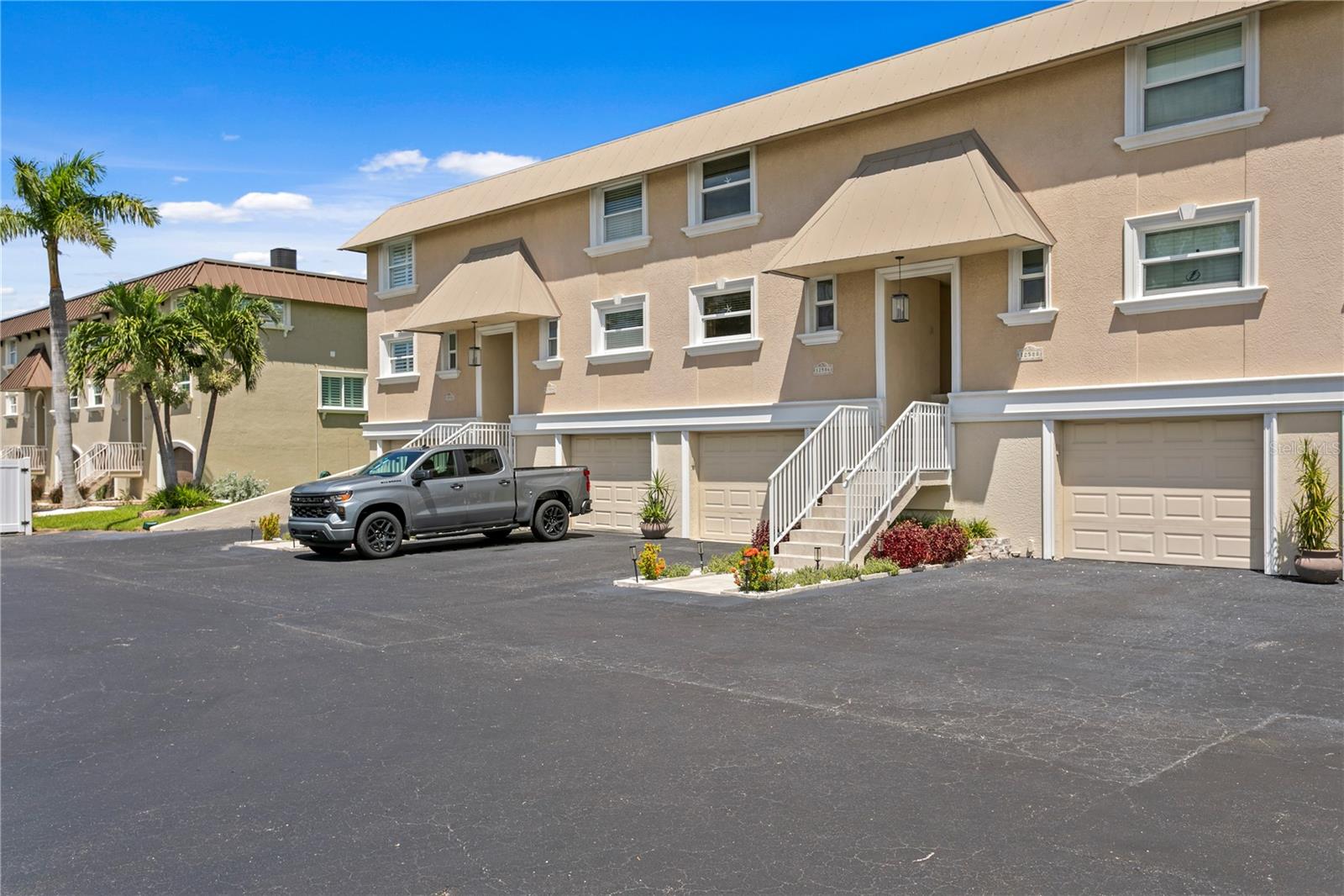 EVERY DAY will feel like a vacation in this BEAUTIFUL waterfront townhome with DEEP WATER PRIVATE DOCK, LIFT, and INSTANT ACCESS to the Gulf. Your sunset and dolphin cruises, fishing, and Eleanor Island SANDBAR ESCAPES start in your backyard - no public launches! Welcome home to manicured lawns and BEAUTIFUL ENTRIES. You will love the stylish OPEN LIVING SPACE on the main floor that boasts rich engineered WOOD FLOORS, a timeless kitchen and island with EXTRA DEEP CABINETS, pull-outs, custom glass, BUILT IN DESK, stainless appliances and thoughtful LIGHTING OPTIONS. Main Floor Designer touches include a convenient POWDER BATH, chandelier cove in the Dining Area, a stone surround FIREPLACE in the Living Area and IMPACT SLIDERS opening to a WATER VIEW BALCONY. The next level holds the PRIMARY BEDROOM with an updated EN SUITE BATH, large closet and PRIVATE BALCONY facing the water. An inviting guest room features an ample closet and a guest bath with an extra wide soaking tub. Between the two bedrooms is FLEX SPACE with laundry, closet, and room for a home office or hobby area. The ground level offers an OVERSIZED one car garage and a Bonus Room with DIRECT ACCESS TO YOUR BOAT. The garage did have water intrusion during Helene but has been PROFESSIONALLY remediated, water-proofed, and UPGRADED with epoxy floors, flow-through vents, and mini-split AC. UNEXPECTED EXTRAS are FEMA PAID Flood Insurance (3 years); PET FRIENDLY COMMUNITY; Annual rentals permitted; Close to Capri Isle Park, Restaurants, Shops and TREASURE ISLAND BEACHES. So many beautiful features you will want to MAKE THIS YOUR HOME TODAY!