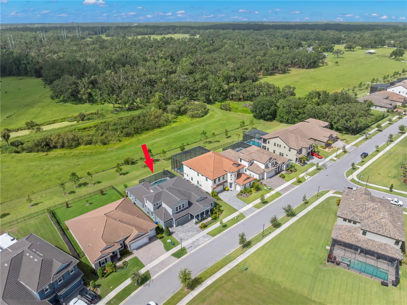 One or more photo(s) has been virtually staged. Hawkstone Artisan is a LUXURIOUS gated community that features executive-style properties constructed by Homes by WestBay. Residents can indulge in resort-style amenities and have access to top-rated schools, including Newsome High School. Just two minutes away, you’ll find the Triple Creek Nature Preserve, where you can enjoy scenic trails, birdwatching, wildlife and recreational activities, including playgrounds, sports fields, and picnic areas. Additionally, the Alafia River is only 15 minutes away, offering opportunities for boating, canoeing/kayaking, fishing, and a variety of restaurants and bars where you can dock and dine! This Award-Winning, Key Largo II, PRIVATE POOL HOME with Craftsman elevation boasts impressive exterior features such as stacked stone, columns framing the covered front porch and a spacious 3-car garage. With just under 4,000 square feet, this home has 5 bedrooms, 4 FULL bathrooms including convenient access to a pool bath. It also features an office, a formal dining area, and a bonus room on each level, all situated on a lot with PRIVACY and beautiful CONSERVATION VIEWS! Elegance and comfort blend seamlessly with a GREAT ROOM that is the center of the home, pre-wired for audio and high ceilings adorned with wood beams. The GOURMET kitchen includes 42” wood cabinets, QUARTZ countertops, walk-in pantry and GE Cafe matte black finish appliances including GAS cooktop and convection oven. The island is GRAND and offers additional storage and seating for SIX and ideal for informal meals. The backyard features a shimmering SALTWATER pool complete with a spillover fountain and sun shelf for lounging. Speakers are in place on the lanai and an outdoor kitchen is pre-plumbed for both gas and electric. The first floor features a primary retreat that offers ample space for a cozy lounging area, along with an en-suite bathroom equipped with an OVERSIZED walk-in shower, a soaker tub, dual vanities, GRANITE countertops, and a water closet. The closet is conveniently accessible from both the bathroom and the bedroom and provides plenty of storage space. Three additional bedrooms and two full bathrooms are on the first floor. The 5th bedroom is upstairs with a full bathroom and bonus room which is ideal for multi-generational living! An electric bill that averages $300/monthly with two Carrier Infinity HVAC variable speed systems that communicate with each other to deliver the perfect amount of cooling (5 ton servicing the first floor/2 ton servicing the second floor). Additional updates and features include timeless finishes, 12 foot ceilings, 8 foot doors and ceramic tile in the living spaces and wet areas, upgraded carpeting in the bedrooms, luxury vinyl tile plank flooring on the second floor bonus room, tray ceiling/crown molding in primary, lighted ceiling fans throughout, epoxy garage floor and paver driveway, walkway and lanai/pool area. The community is PET FRIENDLY, allowing up to 4 pets with no weight limitations! Local restaurants and shopping, 40 minutes to Tampa International Airport, numerous beaches less than an hour away including the #1 Rated St. Pete Beach and just an hour away to Orlando attractions!