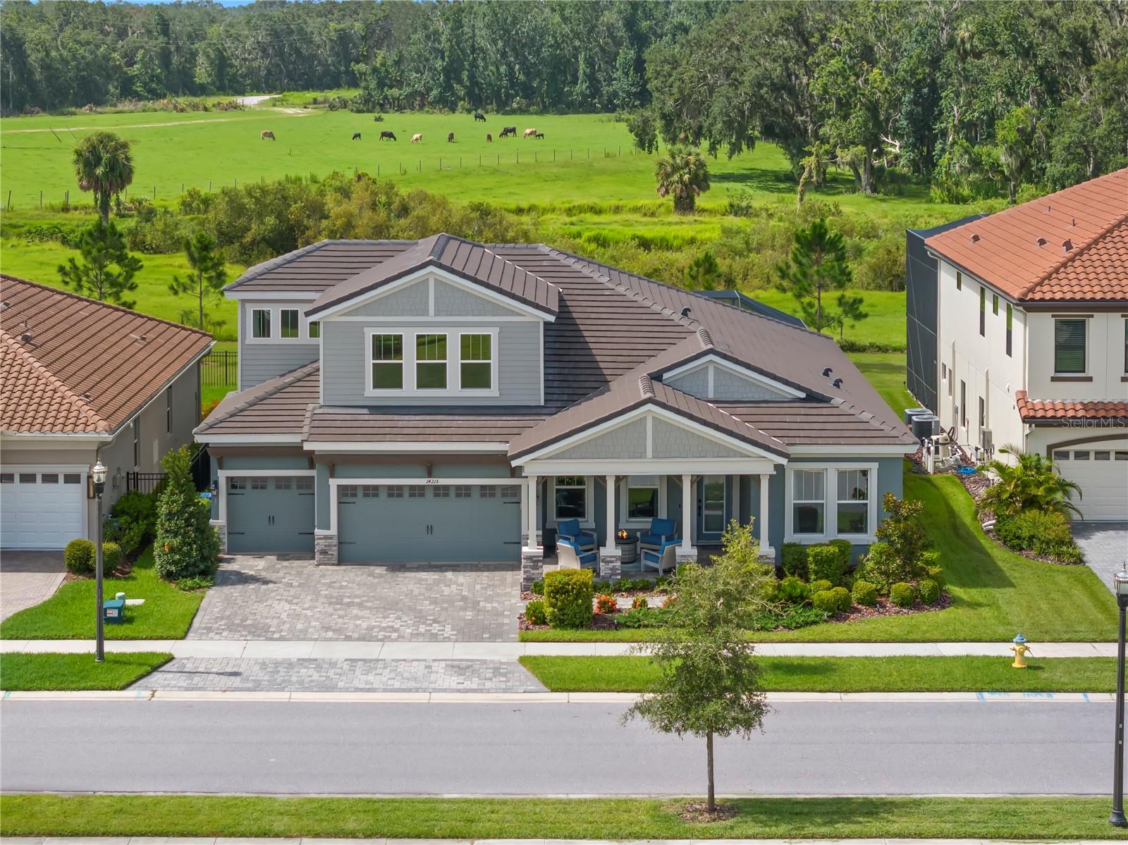 One or more photo(s) has been virtually staged. Hawkstone Artisan is a LUXURIOUS gated community that features executive-style properties constructed by Homes by WestBay. Residents can indulge in resort-style amenities and have access to top-rated schools, including Newsome High School. Just two minutes away, you’ll find the Triple Creek Nature Preserve, where you can enjoy scenic trails, birdwatching, wildlife and recreational activities, including playgrounds, sports fields, and picnic areas. Additionally, the Alafia River is only 15 minutes away, offering opportunities for boating, canoeing/kayaking, fishing, and a variety of restaurants and bars where you can dock and dine! This Award-Winning, Key Largo II, PRIVATE POOL HOME with Craftsman elevation boasts impressive exterior features such as stacked stone, columns framing the covered front porch and a spacious 3-car garage. With just under 4,000 square feet, this home has 5 bedrooms, 4 FULL bathrooms including convenient access to a pool bath. It also features an office, a formal dining area, and a bonus room on each level, all situated on a lot with PRIVACY and beautiful CONSERVATION VIEWS! Elegance and comfort blend seamlessly with a GREAT ROOM that is the center of the home, pre-wired for audio and high ceilings adorned with wood beams. The GOURMET kitchen includes 42” wood cabinets, QUARTZ countertops, walk-in pantry and GE Cafe matte black finish appliances including GAS cooktop and convection oven. The island is GRAND and offers additional storage and seating for SIX and ideal for informal meals. The backyard features a shimmering SALTWATER pool complete with a spillover fountain and sun shelf for lounging. Speakers are in place on the lanai and an outdoor kitchen is pre-plumbed for both gas and electric. The first floor features a primary retreat that offers ample space for a cozy lounging area, along with an en-suite bathroom equipped with an OVERSIZED walk-in shower, a soaker tub, dual vanities, GRANITE countertops, and a water closet. The closet is conveniently accessible from both the bathroom and the bedroom and provides plenty of storage space. Three additional bedrooms and two full bathrooms are on the first floor. The 5th bedroom is upstairs with a full bathroom and bonus room which is ideal for multi-generational living! An electric bill that averages $300/monthly with two Carrier Infinity HVAC variable speed systems that communicate with each other to deliver the perfect amount of cooling (5 ton servicing the first floor/2 ton servicing the second floor). Additional updates and features include timeless finishes, 12 foot ceilings, 8 foot doors and ceramic tile in the living spaces and wet areas, upgraded carpeting in the bedrooms, luxury vinyl tile plank flooring on the second floor bonus room, tray ceiling/crown molding in primary, lighted ceiling fans throughout, epoxy garage floor and paver driveway, walkway and lanai/pool area. The community is PET FRIENDLY, allowing up to 4 pets with no weight limitations! Local restaurants and shopping, 40 minutes to Tampa International Airport, numerous beaches less than an hour away including the #1 Rated St. Pete Beach and just an hour away to Orlando attractions!