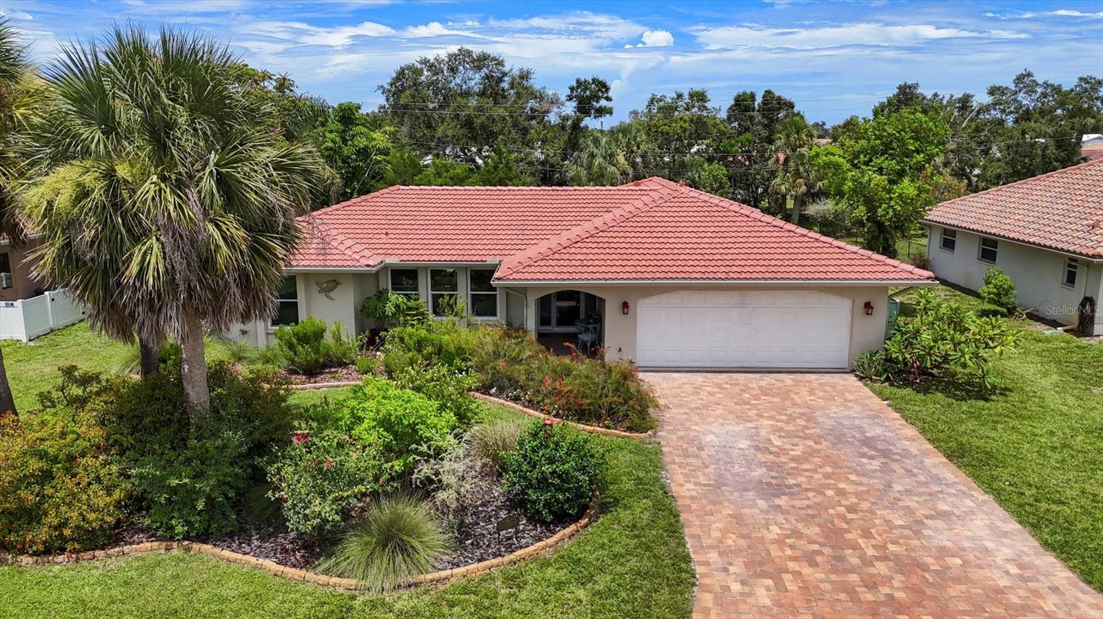 One or more photo(s) has been virtually staged. THE SELLER'S ARE MOTIVATED - BRING YOUR OFFER - LET'S NEGOTIATE! Situated in the desirable Sorrento East community, this beautifully maintained home sits on just over a ¼ acre and offers a serene retreat for gardening and wildlife lovers. The carefully curated gardens have been recognized by the National Wildlife Federation as a Certified Wildlife Habitat, providing food, water, and shelter for native birds, butterflies, and other local species. Inside, you’ll find a warm, inviting layout with tasteful updates throughout. At the heart of the home, the open-concept kitchen and family room create the perfect space for entertaining or relaxed everyday living. The kitchen has been upgraded with solid wood, shaker-style soft-close cabinets, tile backsplash, under-cabinet lighting, a farmhouse-style basin sink, Quartz countertops with a counter-height breakfast bar, and a large walk-in pantry. Engineered hardwood floors flow through the main living areas, adding timeless elegance. The interior is freshly painted in soft coastal hues that enhance the light, airy feel. A spacious screened lanai (accessible from the family room, dining room, and primary bedroom) extends your living space and opens to a paver patio with ample room for outdoor dining, relaxation, and entertaining. The backyard has plenty of ROOM TO ADD A POOL, and the entire property is framed by mature landscaping that provides privacy and peaceful surroundings. Additional features include Hunter Douglas window treatments, HURRICANE IMPACT WINDOWS throughout, and an IRRIGATION SYSTEM (replaced in 2018) that runs off a well. Major mechanical updates offer peace of mind: a brand new ROOF in 2024 with a transferrable warranty, HVAC and ductwork replaced in 2025 with a whole-home UV air purification system, HOT WATER HEATER (2018), GUTTERS (2020), and MAIN SEWER AND LATERAL PIPES RELINED in 2022. Located just next door to Oscar Scherer State Park and the Legacy Trail, this home is a nature lover’s dream with miles of hiking and biking just outside your door. Nokomis Beach and the North Jetty are only 4 miles away, offering the ultimate Florida coastal lifestyle. Best of all, this property is not in a flood zone – flood insurance is NOT required.