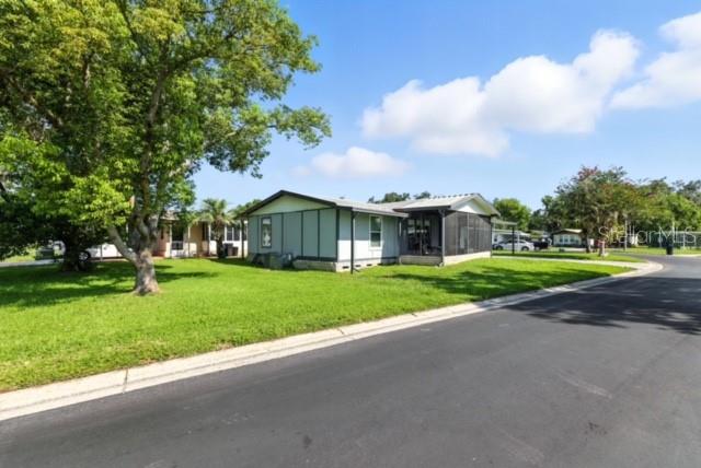 OPEN - BRIGHT: Floor plan. 3 bedroom, 2 bath doublewide mobile home located on a pretty corner lot in a beautiful gated community with no age restrictions! This open split bedroom floor plan features an eat-in kitchen with a conveniently located laundry room just off the end, plus a newer HVAC system installed in 2023. Enjoy relaxing on the front screened porch, covered parking under the 2-car carport, and additional storage in the shed. Just a short stroll to the community pool and clubhouse. This GATED pet-friendly neighborhood (with some breed restrictions) offers security, two pools, two clubhouses, and a low monthly fee that covers lawn maintenance, water, sewer, and trash. Conveniently located near grocery stores, home store, gym, eateries, and Wiregrass Town Center. Why pay rent when you can own this affordable and comfortable home?