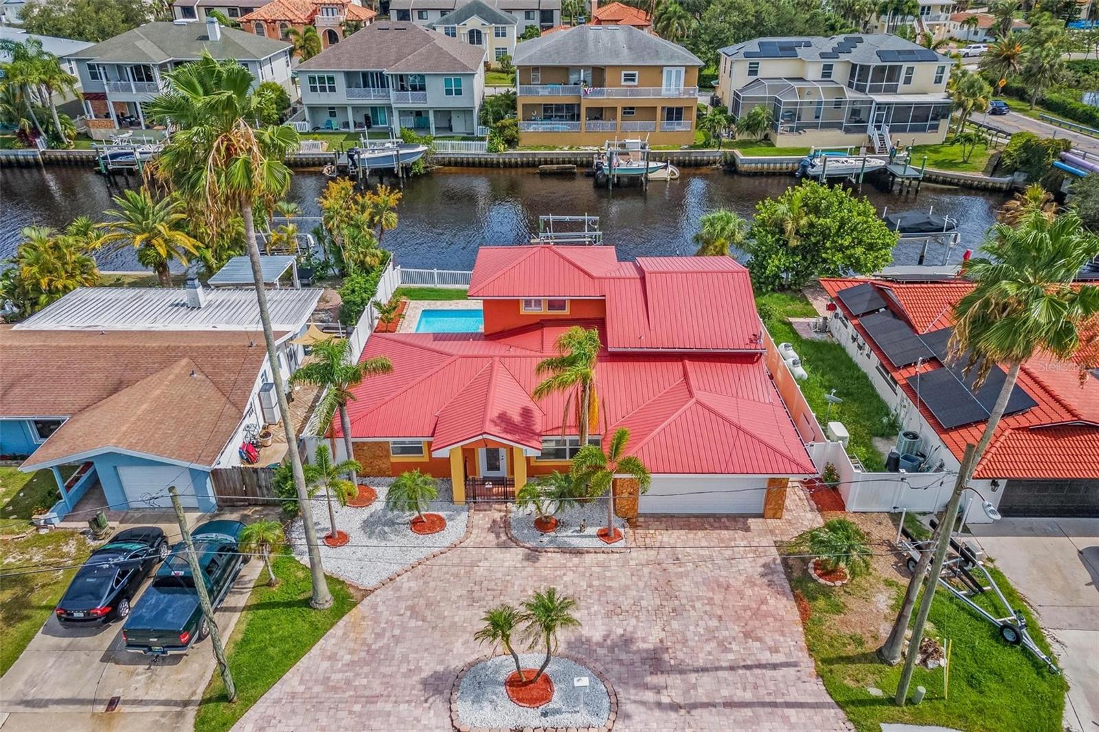 Waterfront Living at Its Best – Heated Pool, In-Law Suite & Direct Gulf Access. Tucked away on a quiet canal just minutes from the Anclote River, this beautifully updated 4-bedroom, 2.5-bath pool home offers the perfect blend of flexibility, functionality, and Florida waterfront charm. With direct boat access to the Gulf of Mexico in just 15 minutes, and only 7 minutes to the iconic Tarpon Springs Sponge Docks, the location truly speaks for itself. Whether you're accommodating extended family or simply looking for extra space and privacy, the home’s unique upstairs suite offers a full kitchen, spacious bedroom, living area, and full bath—an ideal setup for guests, in-laws, adult children, or even a luxurious upstairs primary retreat. Downstairs features three additional bedrooms and 1.5 baths, along with a stylish new kitchen (2025) outfitted with granite countertops and an open flow into the dining and family rooms. Travertine tile flooring adds warmth and elegance throughout the main living areas, and triple sliding glass doors open to a backyard built for enjoyment—with a heated, L-shaped pool, paver patio, and gorgeous water views. Other standout features include a durable metal roof, a fully fenced backyard, sprinkler system, boat lift and davits—ready to accommodate all your water toys—and just steps away from Rotary Park, where kids can run and play.
Located in unincorporated Pinellas County, the property is in a rental-friendly area, making it a great option for investors looking to take advantage of the strong short-term or long-term rental market. Whether you prefer your primary bedroom upstairs or downstairs, this flexible layout has you covered. Close to shopping, dining, and the renowned Innisbrook Golf Resort, this home checks all the boxes for full-time living, vacation use, or investment income. Opportunities like this don’t last long—schedule your private showing today!