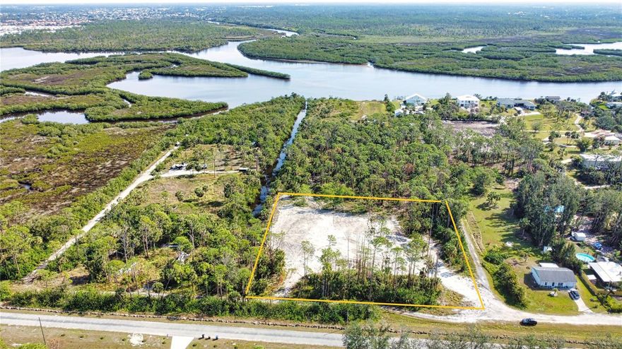 Discover a rare and exciting opportunity to design and build your dream home on this stunning 2-acre residential parcel with direct access to the Myakka River. Tucked away in a serene and private location, this property offers a harmonious blend of natural beauty and convenience. Nestled just north of the picturesque Myakka State Park, the land is bordered by pristine Florida nature, providing an idyllic setting for your future home. The property is situated at the end of a canal leading directly to the Myakka River, offering a unique lifestyle for nature lovers, boating enthusiasts, or those seeking a peaceful retreat. Despite its secluded feel, the parcel is conveniently located just east of the highly desirable Wellen Park community, ensuring access to shopping, dining, and other everyday amenities. Looking to the future, the planned extension of River Road will further enhance the location's accessibility, providing a direct connection to the newly built high school and the pristine sands of Manasota Key Beach. This property truly offers the perfect combination of tranquility, convenience, and potential. This 2-acre corner lot on a canal is zoned RE1, has an active single-family permit, and comes with a clean environmental survey—ready for immediate development. The seller has enhanced the property by bringing in over 500 truckloads of soil, which has been compacted and leveled to a 12-foot elevation, creating a buildable pad approximately 180’ x 80’. Additional improvements include installed silt fences, a newly dug freshwater well, a transformer pad, and underground electrical conduit, making this property truly ready to go.  Seller has plans for a fully permitted barndominium style residence (see photos) available to purchase. Lot dimensions are approximate and should be verified by buyer.  Please see additional parcels that are available - MLS # A4637409, A4637412 and A4637413.
