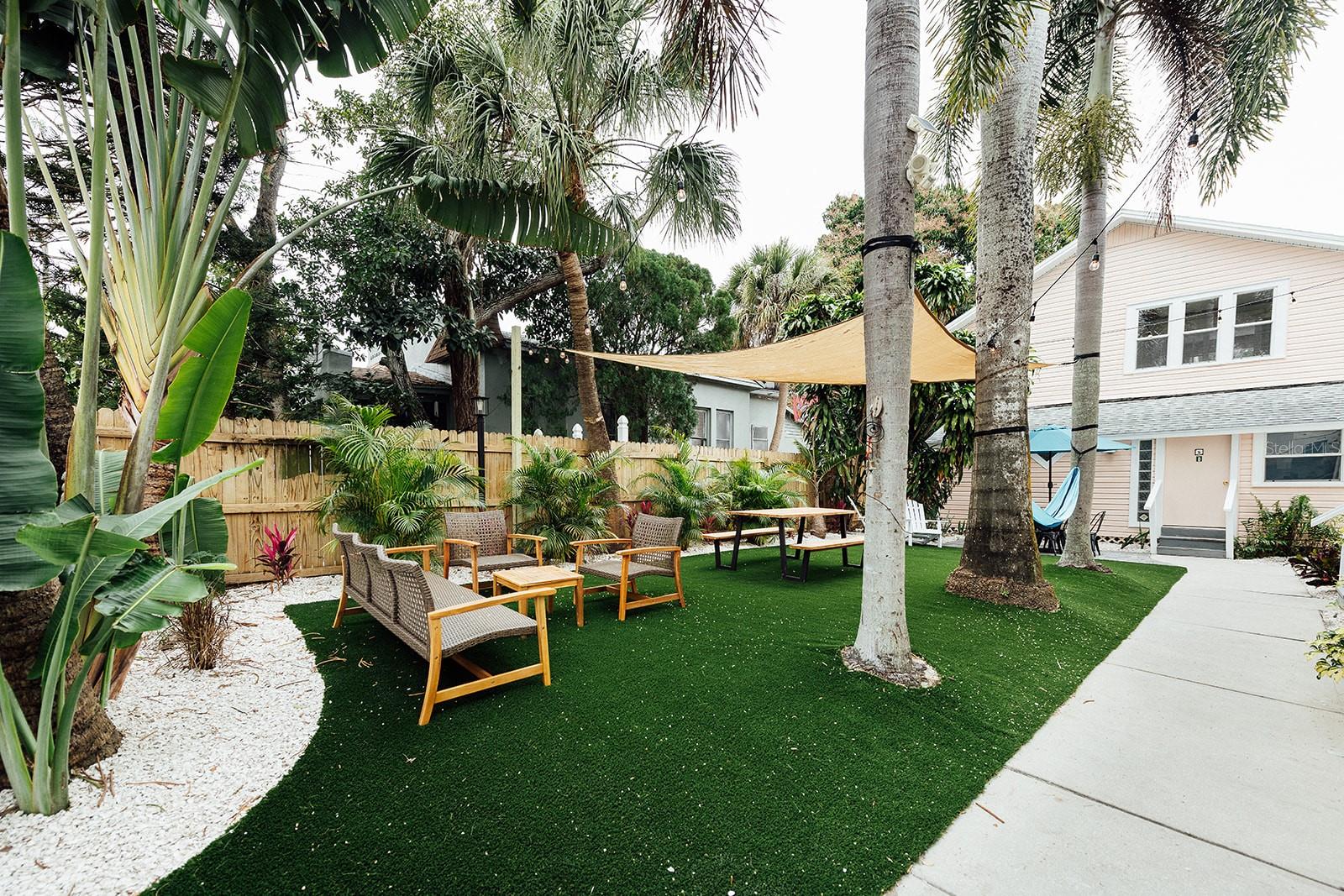 Available for midterm or long-term rental (30+ days) – no short-term rentals. No pets (service animals only).
Step into the vibrant Key West vibes of Mallory Square in charming downtown St. Petersburg! This Conch Republic-themed 2BR/1BA downstairs unit is part of a boutique Key West-inspired complex, designed to feel like a private island retreat in the heart of the city.
This fully furnished and fully stocked apartment features fun, unique Key West décor inspired by the Key West life style, from the pink bird wallpaper to the large scale pelican wall art and coastal accents. Perfect for extended stays, it includes a ?? dedicated workspace with abundant natural light, providing a peaceful and productive work-from-home setup. Rent includes all utilities and high-speed internet, with central AC. Enjoy professional laundry service provided at move-in and move-out, plus onsite shared laundry accessible via app (additional charges) during your stay. Additional cleanings available upon request for a fee. Location Highlights: Nestled in a walkable, colorful neighborhood just minutes from downtown St. Pete, you’re steps from local coffee shops, unique restaurants, and boutique shopping. Explore nearby Central Avenue, Vinoy Park, museums, and take a short drive to St. Pete Beach. Relax in the laid-back charm of Mallory Square’s tropical courtyard with lush landscaping and turf. Move-in Requirements: First month’s rent, cleaning fee, and security deposit. Availability: 7 units total – 1BR/1BA and 2BR/1BA layouts available. Contact agent for availability and pricing.
