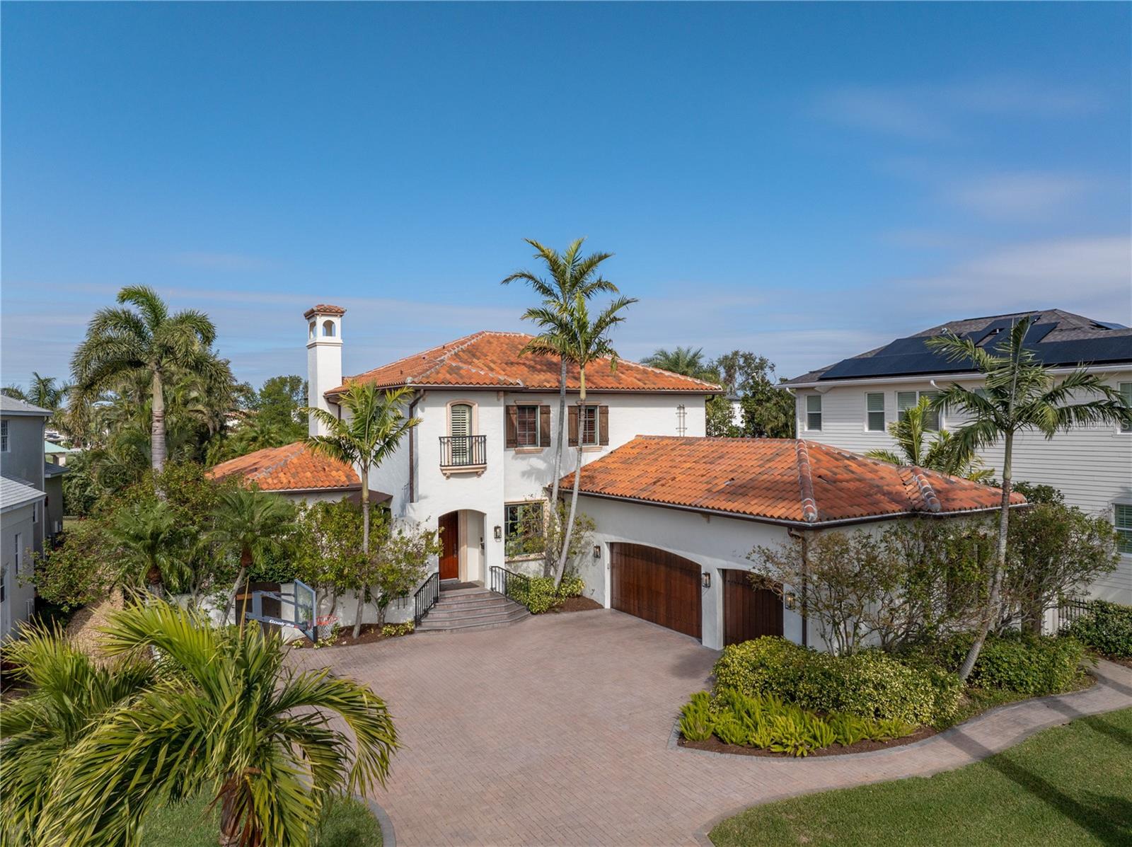 Meticulously crafted by Bright Bay Builders, this breathtaking Mediterranean-style home is a true gem in Snell Isle, overlooking the prestigious Vinoy Golf Course. With 5 bedrooms, 5 baths, and a spacious 3-car garage, this custom-built, all-block home perfectly blends elegance, comfort, and modern functionality.
From the moment you step into the light-filled foyer, you'll feel at home. The formal living and dining rooms are framed by serene views of the pool and warmed by a cozy gas fireplace—ideal for hosting intimate gatherings. The chef's kitchen is a showstopper, featuring high-end stainless steel appliances, a brand-new Sub-Zero refrigerator and freezer, solid wood cabinetry, and stunning stone countertops. With a butler's pantry, dry bar, and abundant storage, entertaining is effortless. The kitchen flows seamlessly into the family room and a casual breakfast nook, making it perfect for everyday living and larger get-togethers.
The first floor includes a private guest suite with an en-suite bath and a thoughtfully designed laundry/mudroom for added convenience.
Upstairs, the luxurious primary suite is a retreat all its own, featuring a private balcony overlooking the golf course and lush backyard. Three additional bedrooms—one with an en-suite bath and two sharing a Jack-and-Jill layout—offer plenty of space for family or guests. A versatile bonus room with custom built-ins doubles as a home office or playroom.
The backyard is your private oasis, designed for enjoying Florida living at its finest. A heated pool and spa, a covered outdoor kitchen, and a dining area are surrounded by tropical landscaping—perfect for al fresco meals and unwinding under the stars.
This home offers beauty and peace of mind, with hurricane-impact windows and doors, a 40 KW generator, and updated HVAC systems (2019 and 2022). Located in the heart of Snell Isle, you'll enjoy easy access to golf, tennis, boating, fine dining, downtown St. Pete's vibrant cultural scene, and the Gulf beaches.
Homes like this are rare—schedule your private tour today before it's too late.