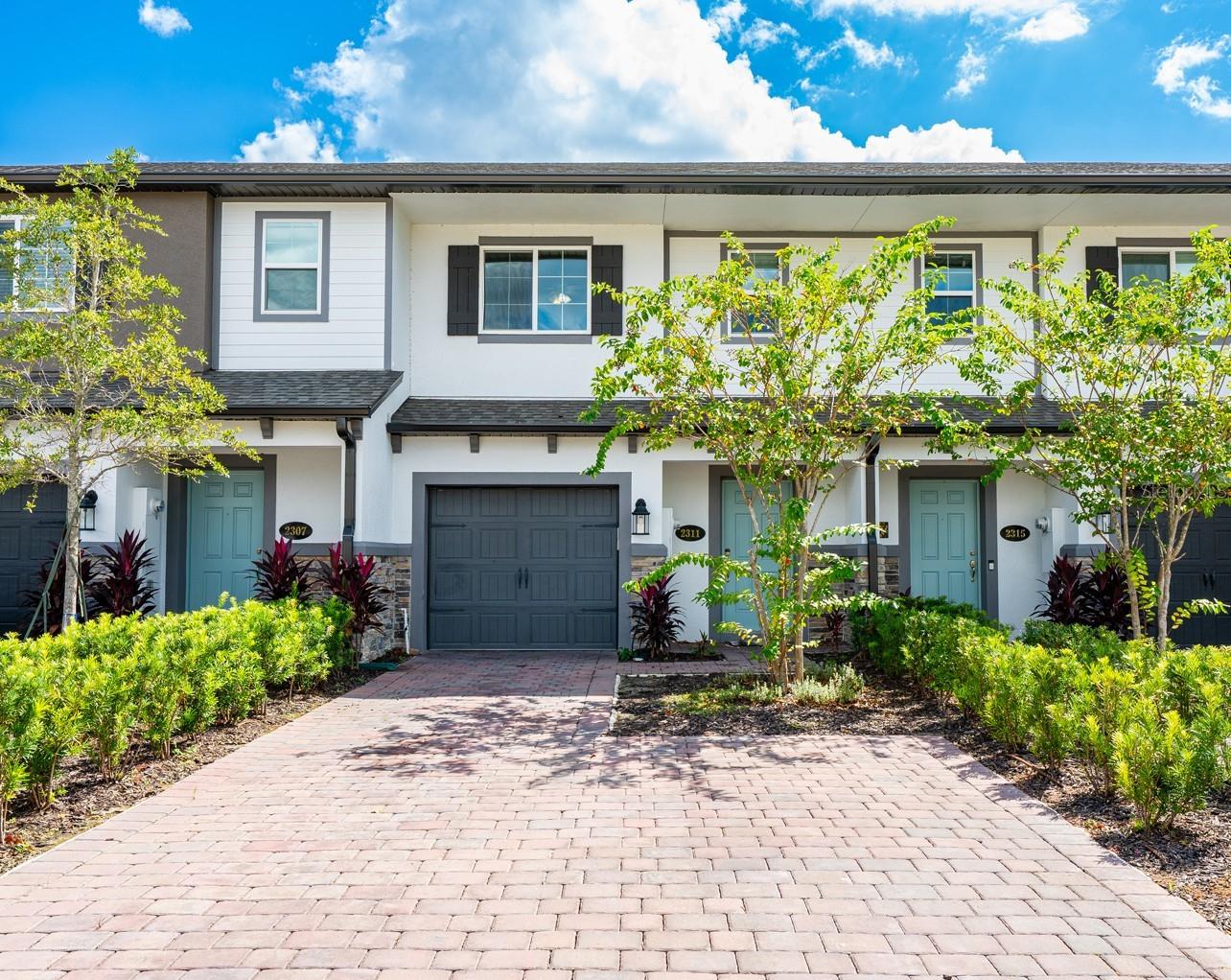 One or more photo(s) has been virtually staged. Ask about a lender provided RATE BUY-DOWN CREDIT on this home! Seller may consider buyer concessions if made in an offer **WELCOME HOME** Built in 2023, this MOVE-IN READY townhome in the desirable Towns at Lake Monroe Commons offers modern comfort, style and convenience in one of Sanford’s newer communities! Meticulously maintained and in excellent condition, this home features thoughtful UPGRADES and a fresh, on-trend design that create instant appeal. From the moment you arrive you will appreciate the attractive CURB APPEAL, enhanced by manicured landscaping, a paver driveway, even the garage was considered and has an epoxy floor! Stepping inside, you will find WOOD LOOK TILE FLOORING throughout your main living areas, paired with plush carpet in the bedrooms for a warm and inviting feel. The OPEN CONCEPT floor plan is filled with natural light thanks to sliding glass doors that frame a relaxing WATER VIEW and open to a patio. The spacious living and dining areas flow seamlessly into a stylish kitchen – complete with STAINLESS STEEL APPLIANCES, a subway tile backsplash, pantry storage, ISLAND with bar seating, upgraded faucet, and recessed lighting. Upstairs, the thoughtful layout places the PRIMARY SUITE at the front of the home for added privacy. Your retreat features a generous WALK-IN CLOSET and well appointed en-suite bath with a dual sink vanity and a walk-in shower, updated in 2024 with new shower glass. At the back of the home the secondary bedrooms share a full guest bath, creating a smart separation of space. A convenient second floor laundry keeps chores simple, while a half bath on the main level makes hosting guests effortless. Amenities include a sparkling COMMUNITY POOL just down the street, and the location can’t be beat. Minutes from the Sanford RiverWalk, Fort Mellon Park, Lake Monroe, Downtown Sanford, and the Central Florida Zoo & Botanical Gardens, you will have endless options for dining, shopping, and recreation. Easy access to SR 417 and I-4 also makes commuting a breeze. This is your opportunity to own a like-new townhome with updates already in place, a water view to enjoy daily, and a LOW MAINTENANCE lifestyle in one of Sanford’s most convenient areas. Every detail has been designed for both comfort and style – clean, bright, and completely move-in ready – call today to schedule a tour!