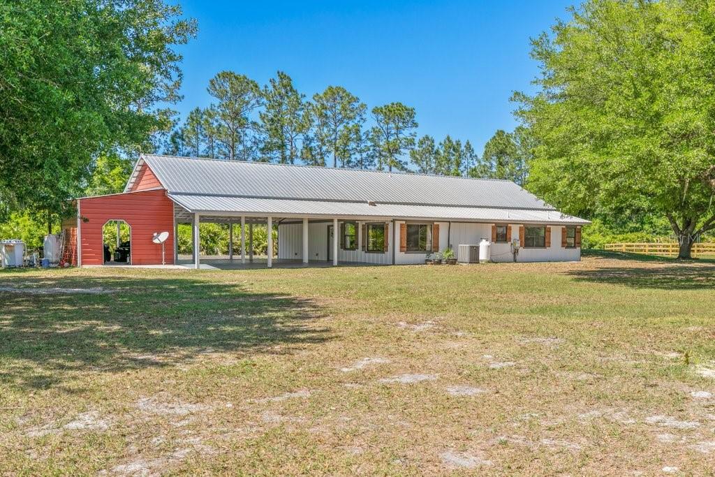 Enjoy peaceful country living on 5.58± acres of high-quality land with established grassy pastures and scattered mature oak trees—an ideal setting for horses, homesteading, or simply room to breathe with no HOA restrictions. Nestled amongst large parcels for added privacy, the property is mostly fenced with classic 3-board fencing and sits off a paved road with a freshly re-surfaced gravel shared driveway. This beautiful home is designed for real living—from the inside out. With a spacious open-concept main living area that offers plenty of room for family and friends to gather and unwind and durable tile and LVP flooring throughout. The kitchen includes a commercial-grade gas flat top cooktop and a massive walk-in pantry, perfect for stocking up on staples. The primary suite offers two oversized walk-in closets, a soaking tub, and a separate shower. Recent upgrades include brand new Hardie board siding (2025), newly painted exterior (2025), a new septic system (2024), and a new tankless gas hot water heater (2025)—all geared toward low-maintenance living. The three-bay carport is ideal for hosting family gatherings, while the outdoor shower provides a convenient spot to rinse off after a full day on the farm. Multiple barns provide versatile options to suit your needs—including a 36’x60’ pole barn with a 30-amp hookup, a large shed, and an additional barn with a concrete floor. Whether you need space for storage, a workshop, or want to convert a structure into horse stables, the setup is ready to support your vision. This property offers the space, simplicity, and freedom to truly live your way.