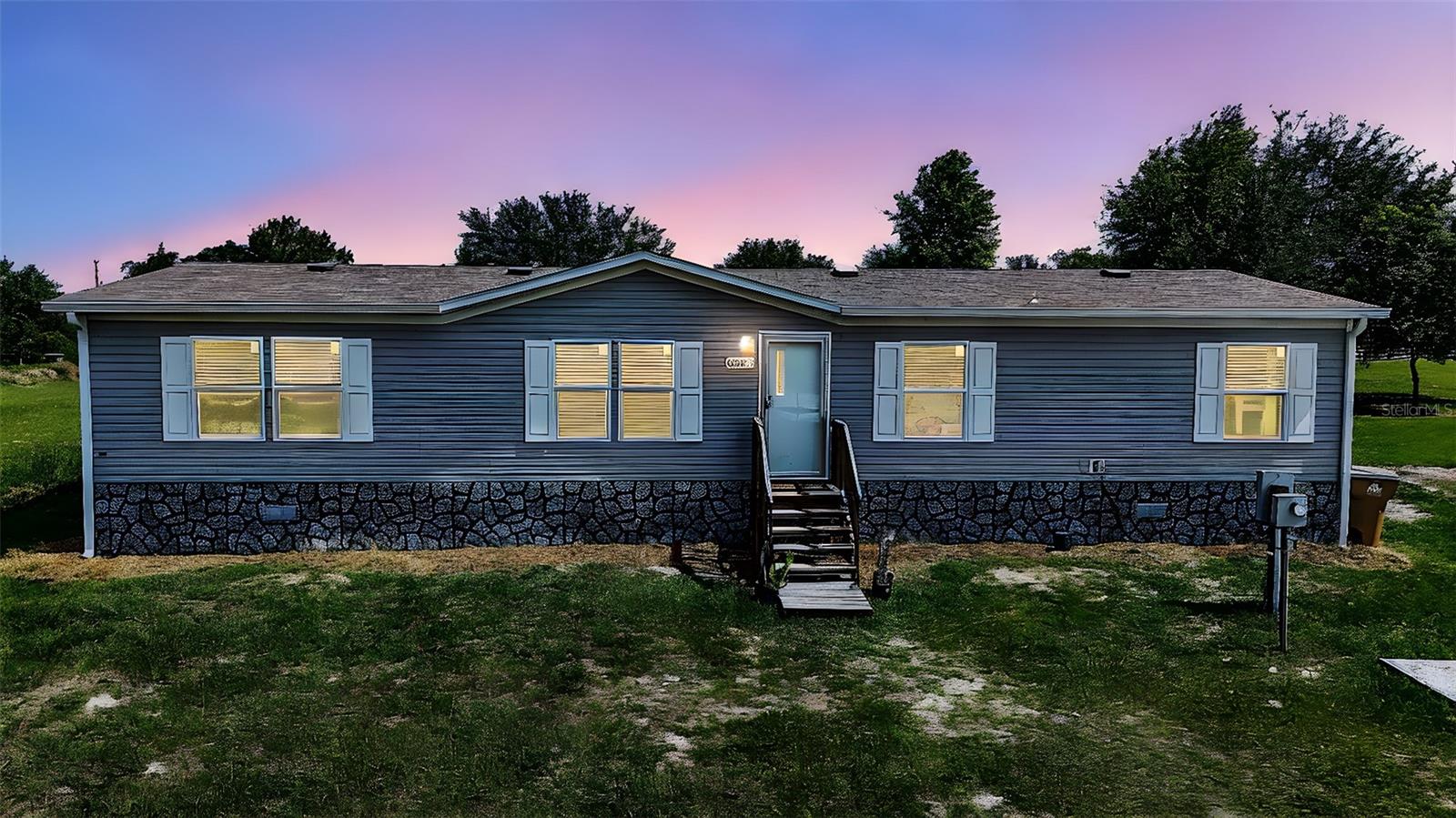 **Seller is willing to contribute $10,000 toward closing costs and/or pre-pairs.** Discover an exceptional opportunity at 8507 Strawberry Fields Court, a remarkable property featuring nearly four acres of possibilities. Built in 2020, this four-bedroom, two-bathroom manufactured home offers a fresh and inviting interior with thoughtfully remodeled kitchen and bathrooms.The expansive nearly four-acre lot is a true highlight, providing ample space, privacy, and the freedom you've been looking for. The property is fully fenced and gated, ensuring security and peace of mind. For those with recreational vehicles, an electrical hookup, water, and septic for an RV or camper are already in place, and the driveway has been widened to accommodate multiple vehicles.Adding to its unique appeal, this property is zoned agricultural, allowing for livestock animals such as horses, cattle, sheep, goats, and chickens. With the allowance for two homes to be built, this versatile acreage offers endless flexibility for future expansion or additional dwellings.This is a rare chance to own a spacious and adaptable property in Howey in the Hills. Showings are by appointment only.