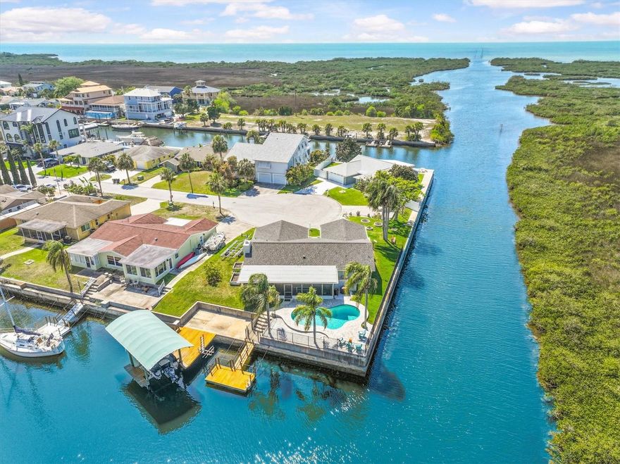 VERY RARE FIND.. NO Steps Here! And NO Flooding in this Beautiful Updated Ground-level Waterfront POOL Home with the Boating Lifestyle Homeowners Dream about. Only Minutes to the OPEN Gulf with 215 ft of Water Frontage. Tucked away on a quiet cul-de-sac, this property offers the Rare Combination so many Buyers are searching for-Ground-level Convenience, a Home that has Not flooded, Tasteful Updates throughout, and a setup designed for Serious Enjoyment on the Water. Outside, the (2017) Wrought Iron Fenced Backyard is made for Relaxing and Entertaining with a POOL (Resurfaced & Salt Water System added in 2018), plus a New (2024) Variable Pool Pump, a Polaris hose-less Pool Vacuum, Adorned by Palm Trees & Attractive Paver Decking (2018), a Floating Dock (2021) for easy Loading and Unloading, a 250 lb Kayak Lift, and a (2018) Fixed Dock with a Covered 10,000-Pound (2018) Boat Lift.  Boat Lift Cover was added (2021) as it is an Important Feature that helps protect your boat from the harsh Florida sun. From your Waterfront Backyard, you can be out to the open Gulf in a couple minutes, making this an Exceptional Fit for Boaters, Fishermen, and anyone who wants Fast, Easy access to the Gulf. The Home also enjoys added Privacy with Preserve Views across the canal. Inside, the Home has a Warm, Inviting Feel with Natural Light, Beautiful Water & Preserve VIEWS, and Updates that make it feel Comfortable & Move-in ready. The Living Area is accented by a Charming Stone Wood-Burning Fireplace with a New (2021) Mantel and Open Vaulted Beamed Ceiling, while the Kitchen has Wood Cabinets (Pot Drawers, Lazy Susan, Cookie Sheet Cabinet), Granite Counters, Island/Breakfast Bar & has been Refreshed with Stainless Steel (2021) Appliances, Updated Backsplash and canned LED lighting and provides an Open Flow into the Dining & Living Spaces that is perfect for everyday living or entertaining guests. Love that the Flooring has all been replaced in 2020 with LV Plank Flooring. The Primary Suite offers a Peaceful Waterfront Retreat with Scenic Views, a Walk-in Closet with Built-in organization, and an Updated Bathroom with New Cabinetry, Dual Sinks & Beautiful Walk in Shower with Glass Shower Door. The additional two Bedrooms are Separate for Privacy. The Guest Bathroom has also been Remodeled with a Walk-in Shower & Updated Vanity. Although not added to the Living Area, the Florida Room which measures 37x12 adds indoor/outdoor living. This Waterfront Home shines not only for its Setting, but also for the many Meaningful Improvements already completed for the Next Owner. Updates include (2018) PGT Storm-Rated Windows and Sliding Glass Doors, New (2021) Interior Doors and Trim, (2021) Double Door Entry Front Doors, Newer (2020) HVAC, (2017) Water Heater, Reverse Osmosis Drinking Water System, a (2017) rebuilt Irrigation System with RainBird Timer, (2021) Insulated Garage Door & (2024) New Driveway, (2021) Epoxy Garage Flooring with a transferrable life-time limited warranty, (2017) Ceiling Fans, updated lighting, and both the Main Roof with 50 Year Owens Corning Duration & Flat Roof replaced in 2024, with the Flat Roof offering a 10-year warranty. Flood insurance is also a plus with assumable primary residence coverage at just 3,345/ year. With a POOL, Covered Boat Lift, Cul-de-Sac Location, Direct Quick Gulf Access, Privacy across the canal, & a home that offers both Peace of Mind and Coastal Style, this is a Rare Waterfront Opportunity that truly checks the boxes