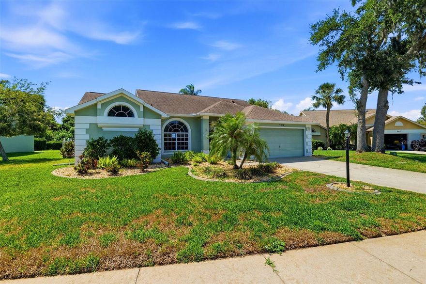 One or more photo(s) has been virtually staged. Step into the Florida lifestyle you’ve been dreaming about in this meticulously maintained 3-bedroom, 2-bath, 2-car garage home located in the highly sought-after 55+ gated golf community of Timber Greens. Tucked away on a quiet cul-de-sac with peaceful conservation views, this home offers the perfect blend of comfort, privacy, and resort-style living. From the moment you walk inside, you’ll appreciate the bright open-concept layout, soaring cathedral ceilings, and inviting living spaces designed for both relaxing and entertaining. The spacious primary suite features sliding glass doors leading directly to your private outdoor retreat complete with a saltwater pool and hot tub — the ideal place to unwind while enjoying breathtaking Florida sunsets and year-round outdoor living. The primary suite also offers two large walk-in closets and an updated en-suite bath with granite countertops, dual sinks, and a beautifully renovated walk-in shower.
The kitchen and den area are light and airy, complemented by gorgeous tile and laminate flooring throughout. Recent updates include new carpet in the primary bedroom (May 2026), AC (2019), and water heater (2019), providing peace of mind for years to come. Beyond the home itself, Timber Greens offers an active and social lifestyle with an 18-hole championship golf course, pro shop, clubhouse restaurant and bar, resort-style pool and spa, tennis courts, fitness center, library, and countless community activities. Conveniently located on the clubhouse side of the community, you’re just moments away from all the amenities, as well as nearby shopping, dining, beaches, and Starkey Wilderness Park. If you’ve been searching for sunshine, relaxation, and an active Florida lifestyle, this home delivers. Schedule your private showing today.