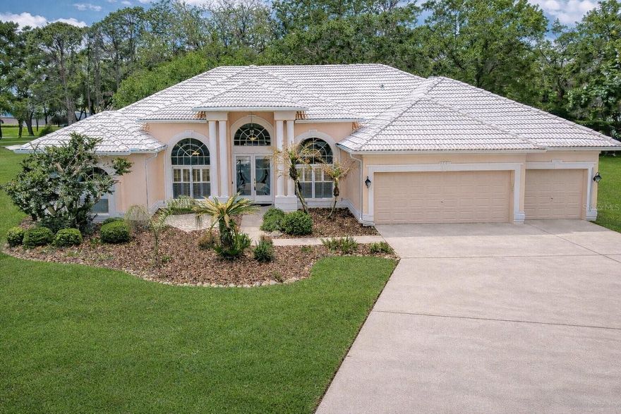 Welcome to River Hills — Where Privacy Meets the Florida Lifestyle. Tucked away at the end of a quiet cul-de-sac on a lush, oversized lot just under half an acre, this stunning 5-bedroom, 3-bathroom pool home offers the kind of space, serenity, and style that buyers dream about. With a 3-car garage and one of the most coveted settings in the community, this is a rare opportunity you won't want to miss. Step inside and be immediately drawn in by the soaring ceilings, abundant natural light, and an effortlessly open floor plan made for both everyday living and unforgettable entertaining. Sprawling glass sliders open up to a sparkling screened lanai complete with a heated pool and spa — featuring both an electric and gas heater, each with the ability to direct heat to either — where you'll enjoy a peaceful, tucked-away setting with no direct rear neighbors and lovely views of the golf course greens — a backdrop that adds a sense of openness and tranquility that truly sets this lot apart. The chef's kitchen is the heart of the home, featuring granite countertops, hardwood cabinetry, and stainless steel appliances — all flowing seamlessly into the great room anchored by a cozy fireplace and walls of windows. Elegant hardwood floors, crown molding, and a formal living and dining room add timeless sophistication throughout — and ceiling fans throughout keep every room comfortable year-round. The triple-split floor plan ensures everyone has their own retreat. The expansive primary suite is a true sanctuary, complete with private access to the lanai, dual vanities, a heated Jacuzzi with 8 jets, separate shower, and two walk-in closets. Secondary bedrooms are generously sized, and the updated guest baths are finished with custom cabinetry and granite. Recent updates include a new water heater (2025) and new AC (2024) — giving you peace of mind from day one. River Hills is a prestigious 24-hour dual manned-gated community zoned for A-rated schools, just minutes from top dining, entertainment, Florida's world-famous beaches, and theme parks. Homes like this don't stay on the market long. Schedule your private showing today and come experience it for yourself.
