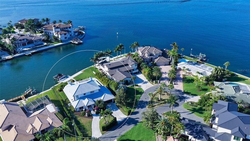 Just three homes in from the open waters of Little Sarasota Bay, this beautifully updated waterfront residence in Southpointe Shores offers a rare combination of location, scale, and immediate livability. Positioned on a quiet cul-de-sac with nearly 100 feet of Intracoastal frontage, the property captures wide water views and direct boating access in one of Sarasota’s most desirable neighborhoods. 
Spanning more than 4,500 square feet across two levels, the home is designed for both everyday comfort and entertaining. An open layout defines the main level, where wood-grain tile flooring connects the primary living spaces and walls of pocketing sliding glass doors open fully to the outdoor living areas—creating a seamless indoor-outdoor experience. 
The recently reimagined pool deck serves as the centerpiece of the home’s outdoor setting, featuring a covered lounge area, summer kitchen with built-in grill, and a resort-style heated pool and spa with sun shelf and waterfall features. The expansive patio overlooks peaceful waters, offering a dynamic waterfront backdrop from morning through sunset.
Inside, the chef’s kitchen has been thoughtfully updated with custom contemporary cabinetry, quartz countertops, high-end appliances—including a built-in Miele coffee station—center island with breakfast bar, and a full-sized wine cooler. The adjacent family room offers vaulted ceilings, water views, and a well-appointed wet bar with built-in shelving, creating a natural gathering space.
Two guest suites with updated en-suite baths are located on the main level, along with a dedicated laundry room. The second floor is reserved for privacy, featuring an expansive primary suite with sweeping water views, fireplace, custom walk-in closet, and a marble en-suite bath. A study and additional bedroom on this level provide flexibility for a home office, fitness space, or nursery.
Recent upgrades enhance both comfort and peace of mind, including impact windows and sliding glass doors (2020), a new seawall (2019), tile roof (2016), updated electrical wiring, modernized baths, and newer HVAC and water heater systems.
Set on an oversized waterfront homesite with direct access to the Intracoastal Waterway, this boater’s sanctuary includes a newer private dock with 27,000-pound lift, accommodating a variety of boating needs. 
Southpointe Shores is a quiet, tucked-away waterfront community known for its proximity to Sarasota’s best coastal destinations. Siesta Key Beach and Crescent Beach are just minutes away, along with marinas, parks, and everyday conveniences. Downtown Sarasota’s cultural attractions—including The Bay Park, Selby Gardens, the Van Wezel Performing Arts Hall, galleries, and dining—are easily accessible, offering a lifestyle that balances privacy with connectivity.