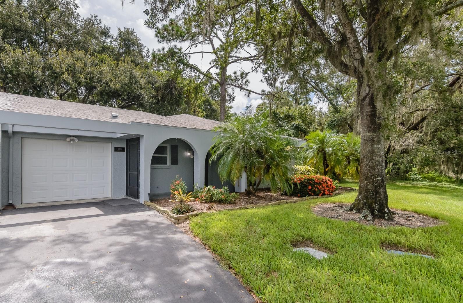 Tucked beneath the shade of moss-draped oaks and overlooking serene lily pad-covered ponds on the Tarpon Woods Golf Course, this 2-bedroom, 2-bath end-unit villa offers a rare opportunity to own a slice of Old Florida charm. Enjoy peaceful views from the newer insulated windows—complete with mini blinds—or relax in the Florida room (which is not included in the sq footage), with 3 walls of windows to surround yourself with nature.
Step inside through the newer cut-glass front door and discover a true blank canvas. "Vintage" kitchen and baths, a quirky 70s stove and microwave that pay homage to the past while balanced by a newer refrigerator and dishwasher—and updated ceiling fans and a modern dining light fixture that give just a hint of today. The oversized tandem 2-car garage offers plenty of storage plus washer/dryer hook-up and an updated electrical panal and new water heater. Also as a bonus, there is a newer storm-grade Overhead Garage Door & Opener. The AC is a Rheem, but the age is unknown. Overall, the layout provides great bones for your creativity & your toys with an unbeatable location!!!
This home is being sold As-Is and will require a roof replacement for financing. If you're looking for character, peaceful views, and the chance to create your dream home in a stunning setting—this is it.
All information is deemed accurate, but buyers are encouraged to verify all details independently.