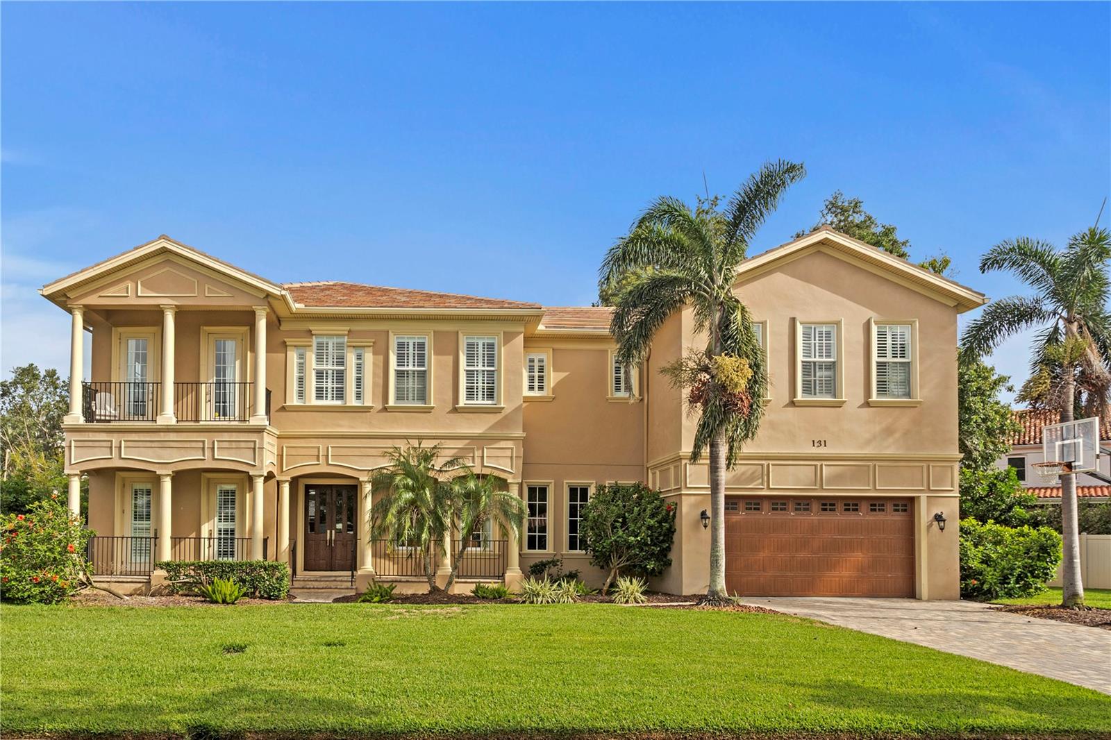 Located in the prestigious and highly sought after enclave of Snell Isle, this elegant two-story residence blends timeless architecture with modern comfort, offering an exceptional lifestyle just moments from the heart of downtown St. Petersburg. Set on an expansive lot with lush landscaping and privacy, this stunning home features a stately façade, covered porches, and generous outdoor living space ideal for entertaining or quiet relaxation. This five bedroom, five bathroom home offers over 4,800+ square feet of living space on an 11,400+ square foot lot, approximately 0.26 acres. Step inside to discover a bright, airy interior enhanced by rich hardwood floors, high ceilings, and custom millwork and crown molding throughout. The thoughtfully designed layout includes multiple living and gathering spaces, a formal dining room with designer lighting, and a spacious chef’s kitchen appointed with granite countertops, solid wood cabinetry, stainless steel appliances, and a central island that invites connection. The family room, complete with a fireplace and built-ins, flows seamlessly to the covered patio, perfect for enjoying Florida’s indoor outdoor lifestyle. The home offers multiple oversized bedrooms, including a luxurious primary suite featuring dual walk-in closets, a private sitting area, and a spa-like bath with a soaking tub and a glass enclosed walk-in shower. Additional highlights include an upstairs loft or bonus room, updated bathrooms with elegant finishes, and abundant natural light from thoughtfully placed windows and French doors. Outside, the tranquil backyard offers endless possibilities, with space to add a custom pool or garden oasis. Ideally situated just minutes from Coffee Pot Bayou, the Vinoy Golf Club, waterfront parks, and a vibrant array of dining, boutique shopping, museums, and galleries in downtown St. Pete, this residence presents a rare opportunity to enjoy refined living in one of Tampa Bay’s most iconic neighborhoods. With close proximity to award winning beaches, top rated schools, and easy access to major thoroughfares, this home truly offers the best of location, luxury, and lifestyle.