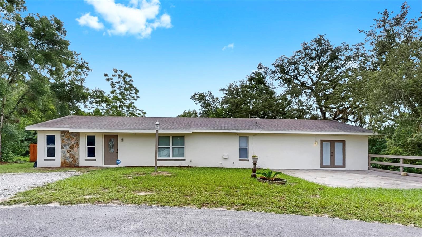 INCOME property and HOUSE HACK opportunity! This updated Dade City home offers dual-living and rental income potential right from day one. The main unit features 3 bedrooms, 2 bathrooms, and a brand new kitchen with quartz countertops, new cabinets, and modern appliances. Attached is a private 1 bed/1 bath mother-in-law suite with its own entrance, full kitchen, washer/dryer hookups, mini-split A/C, and privately fenced yard—ideal for rental income or extended family. Recent upgrades include a new roof (2020), HVAC (2021), and water heater (2022). Included on site is a large covered pad with electricity, perfect for RV storage or an additional income source by renting out the pad. A storage shed adds even more functionality to this move-in-ready, income-generating property.