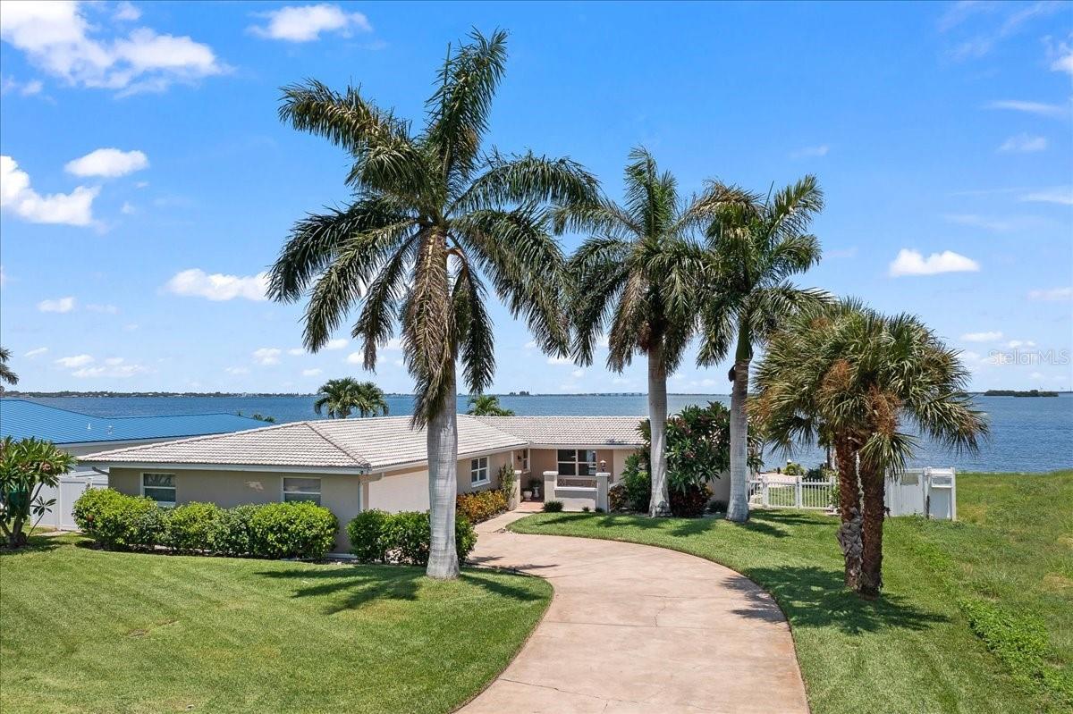 Live the ultimate Florida lifestyle in this waterfront retreat in Cocoa Beach! This well maintained 4 bedroom 2 bath POOL home sits directly on the Banana River's main channel, offering NORTH FACING wide open water views, year round sunrises AND sunsets, and the very best of Florida coastal living! With almost a 100 ft of water frontage, the oversized dock is reinforced with hurricane straps, equipped with a 13,000 lb boat lift, has deep water access, and allows plenty of room for jet skis and kayaks! The interior features a light-filled layout with expansive river-facing impact windows and sliders making storm prep a breeze! The galley kitchen opens to the dining area and has wood cabinetry and granite countertops. The primary suite offers gorgeous water views and direct access to the pool and patio! A true split floor plan, three additional bedrooms are located on the opposite side of the home and provide plenty of flexibility for family, guests, or a home office.
This concrete block home has a concrete tile roof, oversized 2 car garage, knockdown ceilings, tile flooring, 2020 AC condenser, copper water lines replaced to pvc in 2022 and so much more. With NO HOA, this home is perfect as a primary residence, second home or short term rental property and delivers the ultimate waterfront lifestyle. Nestled in the active, beachside, waterfront community of "Country Club" and with views of the cruise ships docked at Port Canaveral, daily dolphin tour boats, rocket launches, manatees, dolphins playing, sunrises and sunsets, there is something different to watch daily. A short walk, bike, or a golf cart ride to World Famous Cocoa Beach, the Cocoa Beach Country Club and Aquatic Center, 27 hole golf course, A+ rated schools, dining, and entertainment you will enjoy living the active FL lifestyle all year long!