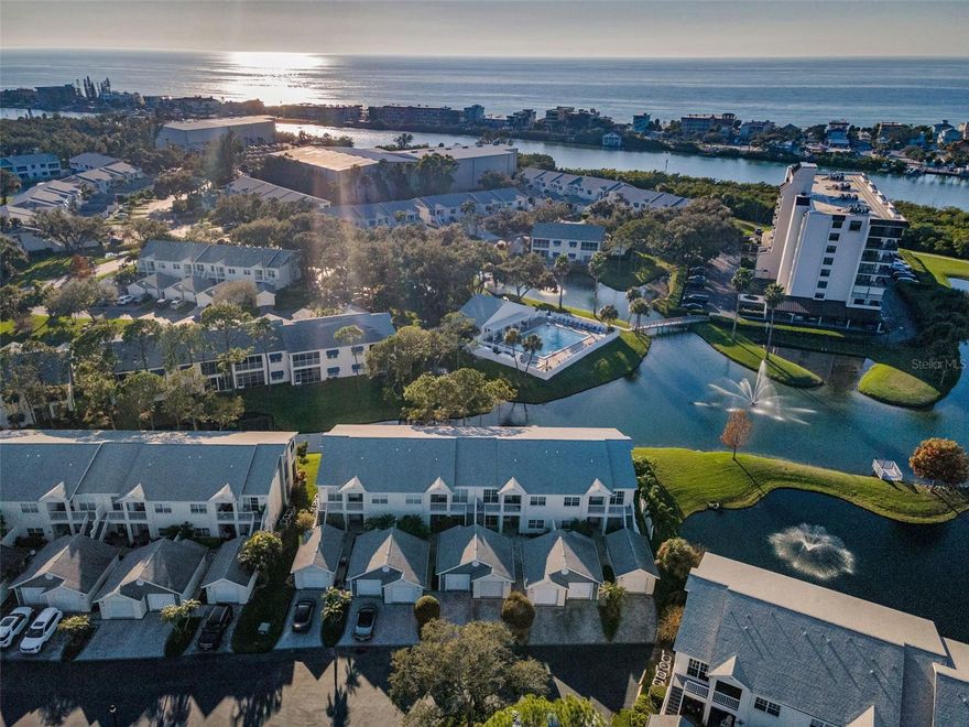 Experience the best of coastal Florida living in the highly sought-after SHIPWATCH community! Shipwatch is a private waterfront enclave with tropical landscaping, an Intracoastal Waterway setting, and RESORT-STYLE amenities. This spacious second-floor, two-bedroom, two-bath condominium includes a one-car GARAGE and a paver driveway with guest parking nearby. The VAULTED CEILINGS create an open and airy feeling as you enter the home. The living room features sliding glass doors that lead to a SCREENED-IN BALCONY overlooking a serene pond, offering a perfect place to relax. This split floor plan provides privacy, with a primary suite set apart from the guest bedroom. The primary bedroom includes sliding glass doors with direct access to the balcony. The oversized primary bathroom features a large walk-in shower and a spacious walk-in closet. The kitchen is thoughtfully designed with Corian countertops, a large kitchen sink, stainless steel appliances, and a lovely pond view. A dedicated closet houses the IN-UNIT WASHER AND DRYER, both of which are included. HVAC was installed in 2023. Situated on 54 beautifully landscaped acres, Shipwatch provides LOW-MAINTENANCE, resort-style living with exterior maintenance and grounds care included. The community completed the building's roof replacement and exterior painting in 2020. Residents enjoy an exceptional array of amenities, including 4 pickleball courts, 11 Har-Tru tennis courts with lessons available, 2 swimming pools (one heated), a hot tub, 2 clubhouses, a fitness room, walking trails, cornhole, a meeting room, a pro shop, an on-site restaurant, a private marina with deeded boat slips, dock access, and security. Shipwatch is a vibrant, active, PET-FRIENDLY, NON-AGE RESTRICTED community with FULLY FUNDED reserves per the HOA. The property is ideally located less than 2 miles from Indian Rocks Beach and just 8 miles from world-famous Clearwater Beach! Convenient travel is easy, with the closest airport approximately 11 miles away and Tampa International Airport just 23 miles away, placing the very best of Gulf Coast living, boating, dining, and coastal recreation right at your doorstep.