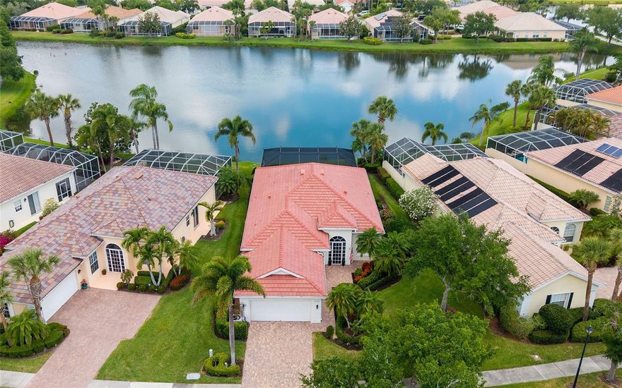 The only home in VillageWalk with a view this good. Positioned on the widest part of the lake, the screened lanai features a panoramic clear-view enclosure that puts the water front and center — wide open, unobstructed and breathtaking.

Step into a carefree Sarasota lifestyle. Sunlit days, beautiful surroundings, and amenities that keep you active and connected. Set on a quiet, dead-end street in VillageWalk, this spacious residence is move-in ready with a brand new roof, remodeled bathrooms, and the kind of built-in peace of mind that's hard to put a price on — steel-reinforced poured concrete construction and underground utilities in a no-flood-zone location.

Inside, 2,201 sq. ft. of light-filled, air-conditioned living space flows through an open layout finished with crown molding, decorative door casings, and a floor-to-ceiling built-in wall system. Sliding glass doors open to a spacious screened lanai with tranquil lakefront views. A reverse-osmosis water filtration system completes the package.

VillageWalk is popular for its resort-style, low-maintenance lifestyle and welcoming, socially active atmosphere. Miles of scenic paths wind through 516 acres of lakes and preserves, while the lakefront Town Center delivers true staycation energy: 24-hour fitness, heated lap and resort pools, tennis and pickleball, and a full calendar of events. Add the convenience of an on-site café, gas station, salon, post office and gift shop, plus a prime Palmer Ranch location near shopping, dining, the Legacy Trail and Siesta Key Beach.