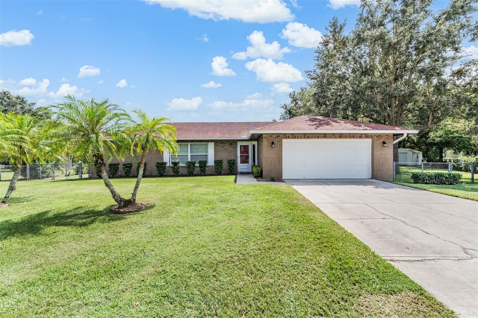 Set on a quiet cul-de-sac in sought-after South Lakeland, this oversized 3-bed, 3-bath home delivers flexible living on an over one-third-acre, fully fenced lot—with no HOA. Just minutes from George W. Jenkins Senior High on Lakeland Highlands Rd, the location makes everyday life effortless.
Inside, durable wood-look flooring carries through most spaces. An L-shaped living/dining room welcomes guests, while the central kitchen anchors the home with a built-in bench breakfast nook, pass-through, and direct access to the great room. The private primary suite features a deep walk-in closet and updated ensuite (shower). On the opposite side, an expansive great room offers space for movie nights or a casual dining nook beside the kitchen. Two secondary bedrooms share a convenient hall bath.
A rear bonus addition (with separate entrance and oversized bath) adapts to your needs: game room, extra living room, or conversion to an in-law/guest suite—ideal for multi-gen living or a future pool bath setup.
Recent updates (per seller): replumbed; water heater (2024); septic drain field ~2 years old; updated vanities; new primary shower; roof approx. 8–10 years old.
If you’re seeking space, flexibility, and a quiet South Lakeland address—without HOA restrictions—look no further!