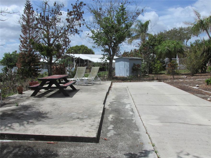 This large .12 acre RV lot is located in the pet friendly, gated 55+ community of Saddlebag Lake Resort, a hidden gem in Lake Wales.  It has a great view of the lake and is flanked by greenways on two sides, adding to your space between neighbors.  The concrete pad will easily accommodate the largest motor coach or travel trailer, with enough space on the side for a boat. There's an elevated concrete patio, perfect for lakeview grilling and picnicking, with plenty of room for lounge chairs for sun bathing.  You'll have full hook-ups for your convenience, and there's a shed on the lot to store all your gear.  The yard is lined with palm trees along the border on one side, and is large enough to put in some plants or do some gardening.  The adjacent home is also for sale - buy both and create a family compound!  Laundry facilities are available in two locations in the resort so you won't have to go far.  You'll be living the dream here!  When you're not out on the lake, you can swim in the community pool or relax in the hot tub.  Get some exercise by playing tennis or pickle ball, or a friendly game of shuffleboard or horse shoes.  There's a fitness center, a rec room with pool tables and saunas, a driving range, even a dog park so your furry family members will feel right at home, too.  The low HOA includes your water, sewer and trash pick-up, plus use of all the amenities.  What are you waiting for? Call now to schedule a private tour!