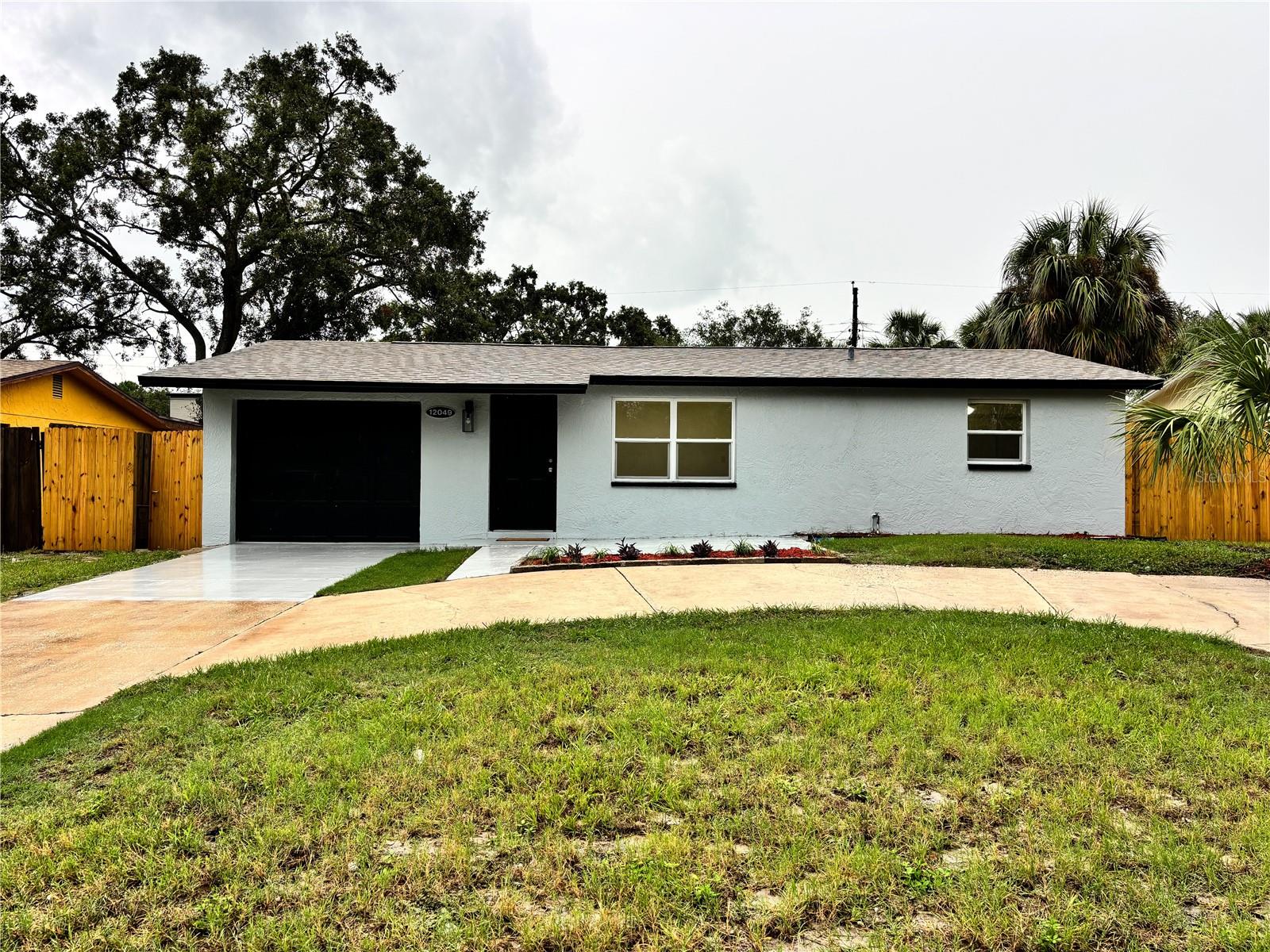 Completely remodeled property in Largo, Florida, just 4 miles from Beach. Don't miss this opportunity to own this home, either to live in or as a rental investment in a high-demand area. This home includes a roof installed in 2021, and everything else is completely new or remodeled: a new kitchen with new cabinets and top-quality quartz countertops and new Samsung kitchen appliances. The kitchen sink has a garbage disposal installed to prevent clogging and a detergent dispenser. The bathroom has been completely remodeled, including a new bathtub, toilet, and vanity, with ceramic floors. New air conditioning was recently installed in 2025, including new ductwork and A/C units. The home also includes new energy-efficient, double-glazed aluminum windows, new doors and windows, and new laminate flooring. All interior walls have been recently repaired and textured, and the exterior walls have been stuccoed. Everything has been freshly painted with modern colors on the exterior. LED lighting is installed in most rooms, including ceiling fans in the bedrooms. The garage was recently painted with floor paint that allows for car traffic, and includes an indoor laundry facility. The plumbing was redone, including the drainpipe. The electrical system was also repaired, including new electrical lines, new circuit breakers in the panel, and all outlets and switches were replaced. The backyard and garden were landscaped and cleaned, with enough space behind the house, including a cemented space ready to build a large deck. The remodeling work was done with the highest quality and attention to detail, making this home a gem in the area. Don't miss this opportunity and schedule an appointment as soon as possible.