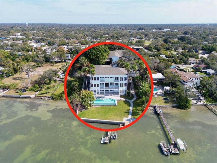 See 1100 N Osceola on You Tube for video!  This is an IDEAL HOME for an IDEAL LIFESTYLE. The main house has 7 bedrooms, 6 full bathrooms and a half bath including a large two bedroom mother in law suite that has a large new kitchen, dining/living space, large bathroom and laundry cupboard. The property is fully fenced, gated, secure and private. The front yard is a picture of old trees and branches, perfect ratio of sun and shade for the Florida climate. Walk down to the main entrance and enter through the front private courtyard that has a stone fireplace and water feature, perfect for small gatherings and entertaining. The entrance is a grand modern foyer with french double glass doors that introduces to you to the main event - THE WATER VIEW. You cant get better than a 180 degrees water view of Clearwater Harbor, and it's visible from nearly every room of the main house. Imagine a different sky every day, a different sunset every night.  You have your own 60 foot dock with electric, water, jet ski lift and entertaining platform suitable for elegant and romantic dining maybe even a private wedding. Blissful. Easily change the jet ski lift to a boat lift. From the grand foyer one walks into the main open living area that extends the width of the house. 3 remodeled floors that are modern, neutral in color, large, open plan with high ceilings, engineered hard wood throughout and travertine in the lower floor recreational area leading out to the pool. Very modern with a touch of "antique restoration". The bathrooms are a delight. The master bathroom is original luxury retaining all its charm, with a deep soaking bathtub, double shower and his and hers vanities. Another bathroom, a whimsical beach fantasy to fascinate guests. Another, a pretty in pink ensuite to remind us we are still girls at heart. And yet another 3.5 modern bathrooms to keep us in present time. The kitchen is also a delight with all that you could desire: modern appliances,  oak veneer, with pre-finished maple interiors, walk in pantry, clean lines, fun pendant lighting.  The top floor contains two bedrooms complete with bathrooms, a full laundry with mini bar fridge and counter space, and another large sitting area suitable for hobbies, an office or simply a boat watching lounge.  The lower floor also has a bedroom and a bathroom to one side and the majority of the floor is recreational space that could be suitable for anything your heart desires. The main floor has two bedrooms and 2.5 baths, formal and informal dining and several living areas including a massive media room.  There is yet another courtyard to take in the wonderful view of the water from the side of the house.  The pool and spa are lighted, heated and made from pebble tech. 6 feet deep. The pool surrounds, 3 balconies, the two courtyards and outer areas of the house are laid with travertine tiles. New roof in 2020. This home is truly a work of ART. Let's not neglect the financial side, this is an IDEAL investment opportunity with future equity to be expected from the growing numbers of population here in Florida. From an income perspective it has: a renovated duplex guesthouse, one bedroom each with living room, kitchen, bathroom and laundry amenities.  Rent them out, or use  for extended family or live in help.  Pure joy and inspiration. All information and sizes on this listing is deemed correct and buyer and their agent are required to do their due diligence.