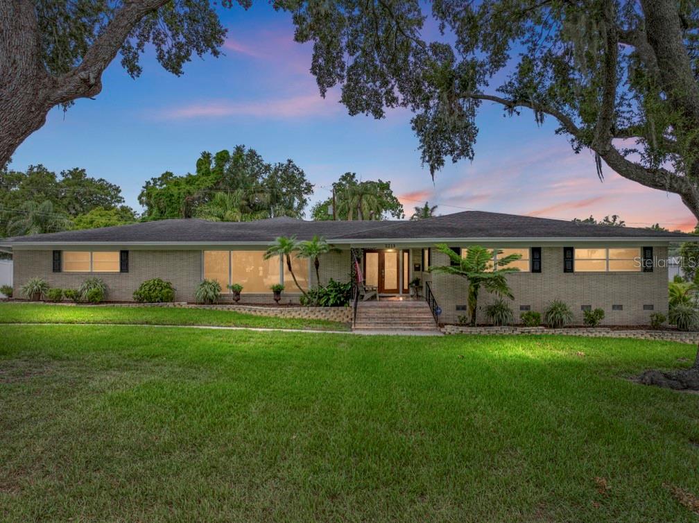 Welcome to 2213 Woodbine Avenue, a beautifully maintained residence nestled in one of Lakeland’s most desirable neighborhoods with close proximity to iconic Lake Hollingsworth. Offering over 2,700 square feet of thoughtfully designed living space, timeless charm, classic buff brick façade and unique features rarely found in the area. From the moment you enter through the double glass doors, you’re welcomed into a gracious foyer featuring hand-laid broken marble flooring. Just beyond, the spacious living and dining room combo with elegant finishes, and a gorgeous picture window that fills the space with natural light. The layout flows effortlessly into a bright and airy family room filled with natural light, featuring hand-laid broken marble flooring, custom built-in shelving and generous space for relaxing or entertaining. The double glass doors open onto the expansive screened lanai and a vinyl fenced backyard situated on large .42 acre lot, this outdoor space seamlessly blending indoor comfort with outdoor living. The heart of the home is the generously sized kitchen, offering ample cabinetry, solid surface countertops, stainless appliances complete with an island, coffee bar, and an eat-in area ideal for casual meals or morning coffee. You’ll also love the indoor laundry room that offers additional storage and convenience. This home features three spacious bedrooms and three full baths, including a primary suite offers 2 closets, including a generous walk-in closet, Jacuzzi tub, walk-in shower, and its own private balcony—a serene and elevated retreat. The dedicated office includes its own full bathroom and private backyard access. One of the home's most uniques features is the basement, offering excellent storage potential or future creative use—another rarity in Florida homes! Additional features include a two-car side entry garage, a double wide driveway with plenty of parking and NO HOA! This Prime location is near Lake Hollingsworth just minutes from downtown, schools, shopping, medical, Polk Parkway, Interstate 4 and County Line Road. Call today for your private showing!