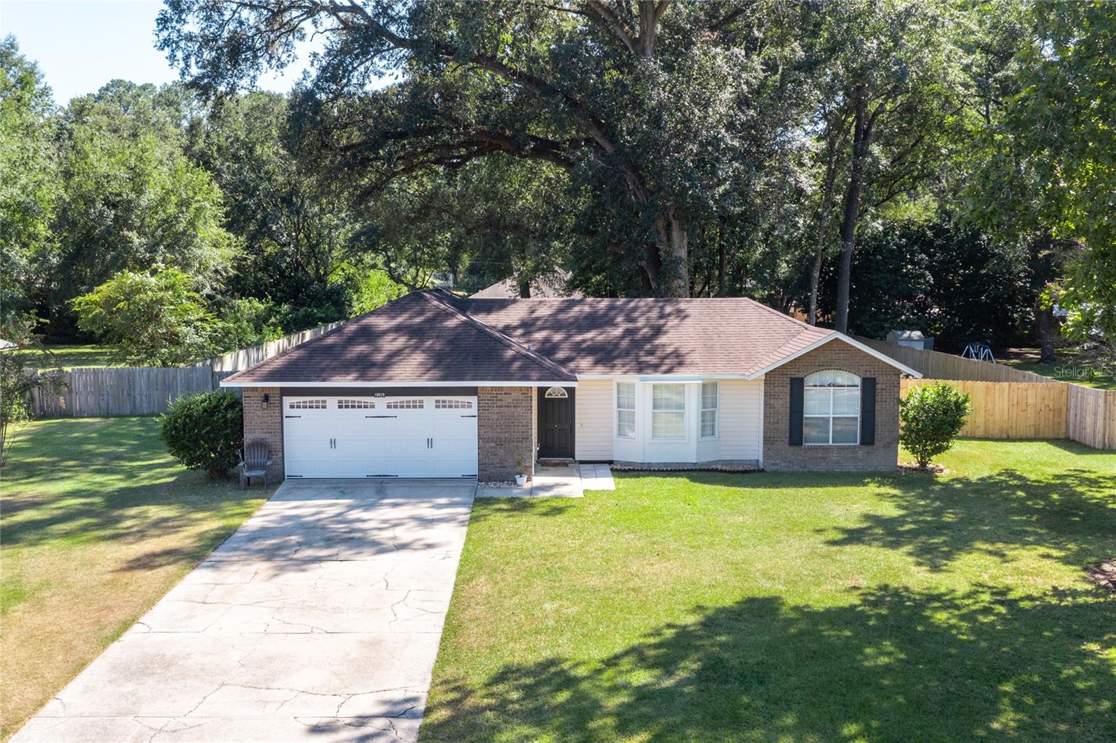 RARE TO FIND in this neighbourhood !!!!
Well-maintained 4-bedroom, 2-bath Ranch-Style home on half an acre! Built in 1995, this home features a desirable split floor plan, a formal living room with bay windows overlooking the manicured front yard. The adjacent dining area features double windows overlooking the expansive backyard. The galley kitchen is bright and finished with white cabinets, stainless steel appliances, and opens to a spacious family room, where sliding doors open directly to the backyard, creating the ideal indoor-outdoor living experience. Luxury vinyl flooring runs throughout most of the home, with light laminate in the two kids’ bedrooms. Both bathrooms include convenient tub-shower combinations. Outside, enjoy a fully fenced backyard—perfect for kids, pets, and entertaining. The two car garage has been freshly updated with a new coat of paint, giving it a clean and well-maintained look.
Conveniently located just 3 miles to Downtown Alachua, barely 16 miles to UF & Shands Hospital, and under 10 miles to Santa Fe College. Wall mounted TV in the living room & Family room convey with the house. Roof 2017, HVAC system replaced under 4 years, also has a UV-C light installed in the HVAC. Air Ducts Cleaned March 2025, Septic serviced and pumped Sept 2025.