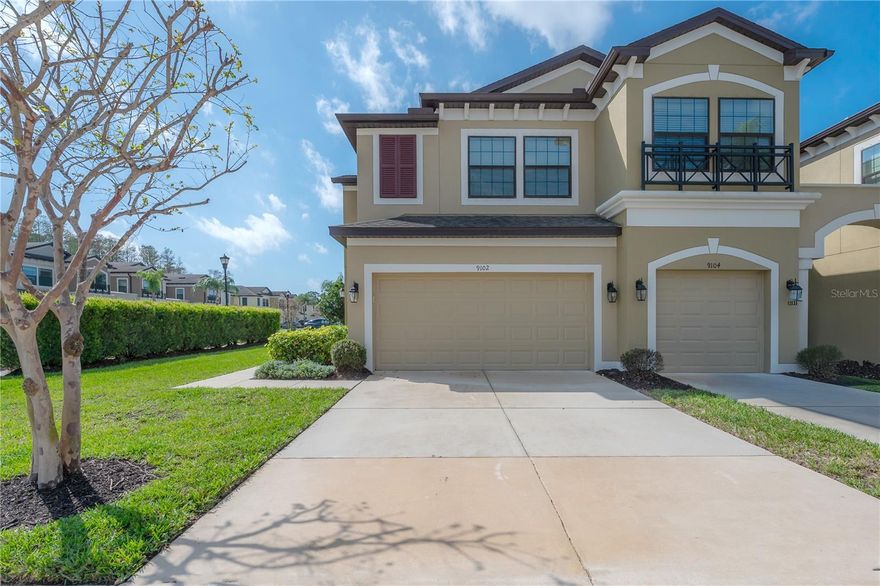 Don’t miss this exceptional opportunity to own a beautifully appointed end-unit townhome in the gated Townhomes of West Lake by M/I Homes, ideally located just minutes from Tampa International Airport, Downtown Tampa and the area’s renowned Gulf beaches. This prime residence features a spacious two-car garage with private driveway and is perfectly positioned within the community—just a short stroll to the pool and abundant guest parking. Step inside to discover an inviting open-concept layout enhanced by wood plank tile flooring, soaring ceilings, crown molding and an abundance of natural light throughout. The expansive kitchen is a true centerpiece, showcasing tall cabinetry, sleek quartz countertops, stainless steel appliances (Dishwasher and Disposal - 2024, Range - 2026), a large center island with seating and a generous walk-in pantry—perfect for both everyday living and entertaining. Additional conveniences on the main level include a discreet powder room and a well-equipped laundry room (Washing Machine - 2025) with utility sink. The Devonshire II floorplan seamlessly connects the living and dining areas, extending outdoors to an extended screened-in patio ideal for relaxing or hosting guests. Upstairs, a spacious loft with vaulted ceilings provides flexible living space and leads to the luxurious primary suite, complete with a sitting area and expansive walk-in closet. The ensuite bath offers a refined retreat with quality finishes, while two additional bedrooms—each with their own walk-in closets—and a full guest bath complete the second level. Impeccably maintained and with the furnishings being offered in the sale, it is truly move-in ready. AC was replaced in 2025 and a water treatment system was installed in 2021. This townhome offers a rare blend of comfort, style, and convenience in one of Tampa’s most desirable locations.