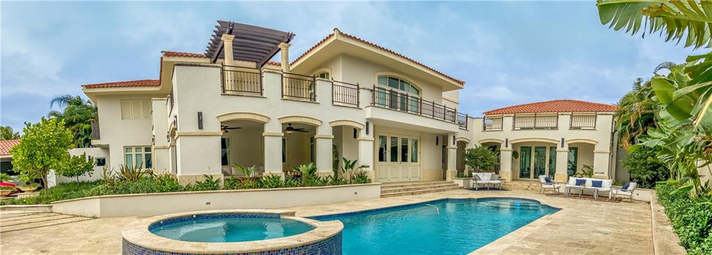 Classic Contemporary Style with Elegance at Dorado Beach East!
Amazing outdoor space with pool house perfect for entertaining.
Great location with views of the golf course.
This extraordinary residence features 5 bedrooms all with private bathrooms, ample master suite with office space, family/tv room, sunroom with green wall, kitchen with breakfast niche, open concept living and dining room that open to the amazing outdoor space that is beautifully landscaped.
The outdoor space consists of a covered terrace with views to the golf course, pool with jacuzzi, pool house with bar area, exterior full bathroom and ample patio with fountain. The beautiful landscape also features a pond.
Property is fully equipped with a new power generator, water cistern, solar water heater.