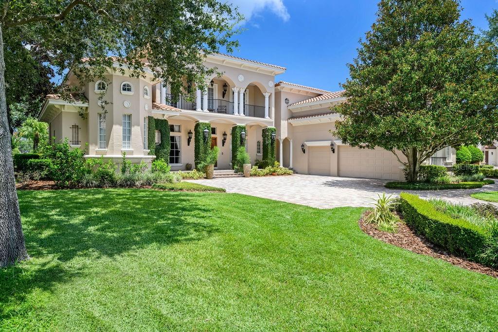 A Masterpiece on the 4th Hole – Keene’s Pointe Luxury Living
Perfectly poised on a premium golf-front lot in the gorgeous, guard-gated community of Keene’s Pointe, this custom-built residence by Unnerstall blends refined craftsmanship with thoughtful design and breathtaking views of the Golden Bear Club’s 4th hole and tranquil water features.
Boasting over 6,100 square feet of impeccably designed living space, this home offers 5 en-suite bedrooms, two private offices, a dedicated fitness room, and a sunroom-style bonus/game room—all tailored for both comfortable daily living and elevated entertaining.
From the moment you step through the grand double doors, you’re welcomed by travertine flooring, elegant architectural detail, and a sense of scale that is both impressive and inviting. The main-level primary suite is an expansive retreat featuring dual walk-in closets and an unforgettable two-story spa bath designed to inspire relaxation. A second bedroom suite on the first floor provides ideal accommodations for guests or multi-generational living.
The heart of the home is the gourmet kitchen, beautifully appointed with custom cabinetry and open to the dramatic two-story great room, creating a seamless flow for entertaining. Upstairs, you’ll find three additional en-suite bedrooms, a flexible bonus room or office, and a private home gym.
Step outside to your personal resort. A screened-in lanai leads to a lush, landscaped backyard with a copper-roofed gazebo, outdoor kitchen and bar, and a sparkling pool and spa—all perfectly positioned for enjoying Florida’s golden skies and outdoor lifestyle.
Additional highlights include an oversized paver driveway, three-car garage plus separate golf cart entrance, Venetian plaster finishes, and designer touches throughout.
Set within one of Windermere’s most exclusive communities, where majestic oaks, lakeside trails, and the Butler Chain of Lakes frame a lifestyle rich in privacy, recreation, and natural beauty—this is more than a home. It’s a statement.