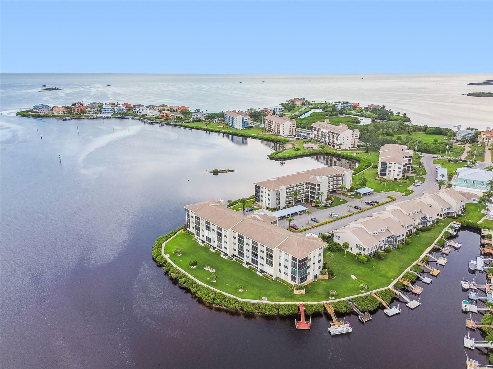 Your early mornings will be spent walking the beautiful waterside grounds, sipping coffee on your private balcony overlooking the water, or exercising in the on-site fitness center. Enjoy continuous “stay-cations” by the pools, water activities on both the river and gulf, playing tennis, or taking short drives to area attractions like the Tarpon Springs Sponge Docks. The A/C was replaced in 2025. The hot water heater in 2025. Your primary bedroom has views to the water, access to the private balcony, an en-suite bath and walk-in closet. The kitchen includes stainless appliances. Hurricane shutters on balcony and primary bedroom. No age restrictions. No pets. Included in monthly fee are basic cable/internet, trash, grounds maintenance, gated 24x7, tennis, fishing pier, clubhouse with fitness center, reserves, exterior maintenance, roof, grounds, hazard and exterior flood. Owners responsible for interior insurance coverage. Does not include a private dock. Close to restaurants, medical, shopping, and more. Do not miss this great opportunity! Schedule your showing today!