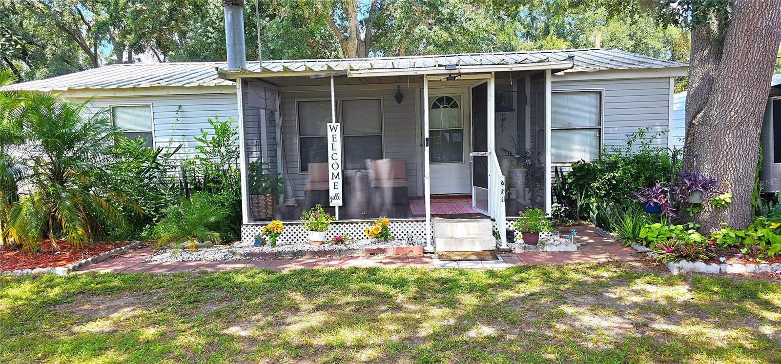 LIKE NEW! NO HOA, NO LOT RENT! Down Payment & Closing Cost Assistance through the Hometown Heroes Program! Beautifully updated 3 BR, 2 BA home on almost half-acre landscaped, dry, high-fenced lot in Winter Haven.
The front yard features a manicured garden that adds charm and curb appeal, welcoming you home from the moment you arrive. Step up onto the inviting wooden front porch and into a freshly renovated interior with an open-concept layout.
The kitchen showcases NEW white cabinets, NEW Butcher Block counters, Stainless Steel appliances, NEW lighting, NEW large farm sink, and a breakfast bar perfect for casual meals and entertaining. NEW Luxury vinyl plank flooring runs throughout.
2022 NEW updates: Plumbing re-pipe, water heater, Reverse osmosis system, electric meter, wood fence, fresh paint, & ADT Security System.
The 22’x12’ Rear screened wood deck w/ramp was designed for relaxing & watching the sunset. Enjoy bbq’s, entertaining, & gardening in the expansive yard that includes two carports and is gated to bring in your big toys, vehicles, RV’s or boats. The large shed with electric in the back is perfect for a workshop/art studio and storage.
Conveniently located with easy access to the Parkway, making commutes to Orlando or Tampa a breeze. Don't miss this unique opportunity for peaceful living with modern comforts!
This move-in-ready gem delivers comfort, space, and freedom Do NOT wait, it will not last long!