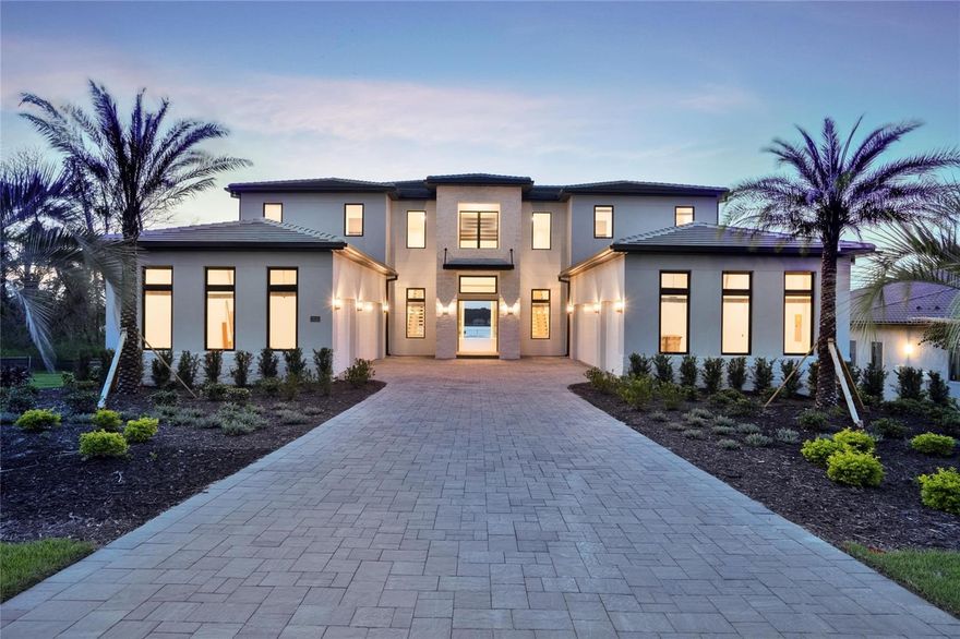 STAND OUT FROM THE ORIDNARY and elevate your lifestyle into the breathtaking realm of Bella Collina! Introducing a newly constructed luxury lakefront residence highly positioned on an expansive acre-plus lot in the exclusive Estates section of the community. Overlooking the serene shores of Lake Sienna, this exceptional home offers panoramic water views, sophisticated interior finishes, and an ultra-impressive outdoor living space designed for both relaxation and entertaining. This is more than just a home, it’s a statement of purpose and meaning. From the moment you step through the covered entry, you’re met with dramatic architectural elements including double floating staircases, a soaring two-story open concept gathering space and uninterrupted sightlines to captivating lake views. The main level has been thoughtfully designed for both convenience and everyday living and features a grand, open concept living, dining, and kitchen area, a luxurious primary suite with lake views, a secondary en-suite bedroom, a versatile flex room, powder bath, large laundry room, and a practical drop zone off one of two oversized three-car garages. Upstairs, a walkway bridge for added privacy separates three additional en-suite bedrooms, a private home office, and a spacious loft and media room prewired with multiple Cat 6 outlets for today’s connected lifestyle. What truly sets this home apart is the outdoor living area with a spacious travertine deck, high ceiling covered lanai, fully equipped summer kitchen, gas fireplace, and a dedicated pool bath and shower - all framed by picturesque water views. The custom-designed infinity-edge pool is flanked by two raised pedestal mounts ideal for fire bowls or water features. A multi-person heated spa and sun shelf invite tranquil moments under the sun.
A stately cascading staircase leads to a lower-level retreat with artificial turf and aluminum fencing—prime for a fire pit or lounging area. A second terraced area below takes you down to a sprawling backyard with over 140 feet of shoreline. Planning to bring your boat? This is one of the select properties that can accommodate a private dock. Completed in April and awaiting your personal touch, this home is an extraordinary opportunity to own in one of Florida’s most prestigious guard-gated, golf communities. Bella Collina spans over 2000 acres and is truly a one-of-a-kind compelling setting from awe-inspiring scenery and topography to a collection of striking homes of distinction offering an unmatched lifestyle for those wanting luxury lakefront living. Highlights of the features and amenities include a Tuscan-inspired hilltop village showcasing a world-class 75,000 square foot clubhouse, ballroom, full-service spa, restaurants and bars. There are also tennis, pickleball courts, a state-of-the-art fitness center, resort-style pool w/ lap lanes, dog park and even a heli-pad. It is conveniently located within easy reach of Orlando International Airport, downtown Orlando, the town centers of Winter Garden, Clermont, Minneola, and the highly anticipated Olympus Project in Wellness Way. Outdoor enthusiasts will love the West Orange Trail just a few miles away. Top rated schools, hospitals, shopping, and dining are close by. Theme parks are a short easy drive... Whether you're seeking an upscale, active way of life filled with social aspects and a variety of choice activities, or a peaceful haven of refined living, 15121 Pendio delivers it all.