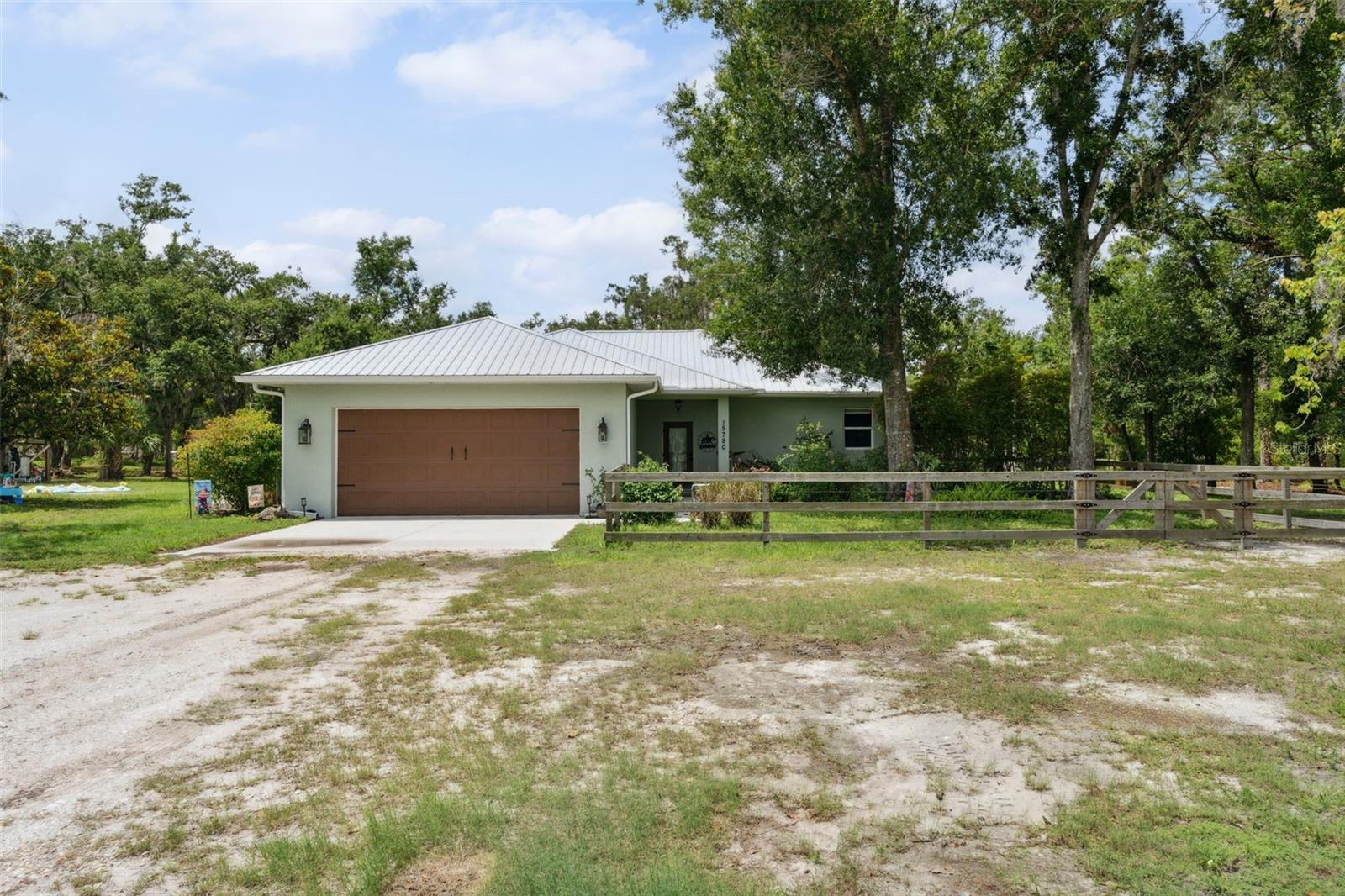 Secluded Sarasota Oasis (Built in 2008) – 8.8 Acres of Peace & Possibilities
Welcome to your private paradise in Sarasota, just minutes from rapidly growing Fruitville Rd! Built in 2008 and Nestled on nearly 9 acres of lush, secluded land in a highly desirable X flood zone, this exceptional 3-bedroom, 2-bathroom home offers the perfect blend of rural tranquility and modern convenience—just minutes from shopping, dining, top-rated schools and more.
This 1,800 sq ft home features an inviting open floor plan under a durable metal roof, ideal for entertaining or enjoying peaceful, spacious living. The gourmet kitchen is a chef’s dream, boasting a center island, breakfast bar, stainless steel appliances, gas stove, and a pass-through window to the screened-in back porch—perfect for indoor-outdoor Florida living.
The spacious master suite is a true retreat with tall tray ceilings, a large walk-in closet, and a luxurious en-suite bathroom complete with a walk-in shower, jacuzzi tub, and plenty of natural light.
Outside, enjoy room to roam, play, or simply relax under the shade of mature trees. The property includes a custom playhouse, a whole home generator, on-site propane tank (owned), and a versatile barn/living quarters equipped with its own kitchen, bathroom, running water, and electric—ideal for guests, extended family, or as an income-producing rental or workshop. The barn is also outfitted with 3 stalls if you want to house horses or other animals.
Upgrades include New Washer, Dryer, and Fridge (2023), New AC (2024), New Hot Water Heater (2024), Whole House Water System Updated (2025), New Storm/Impact Resistant Windows, Sliders, and Gutters (2022), Above Ground Pool (2024)
Whether you’re looking for a serene homestead, a multi-generational setup, or a private retreat with expansion potential, this unique Sarasota acreage checks all the boxes.
Don’t miss the chance to own this rare blend of privacy, functionality, and location!