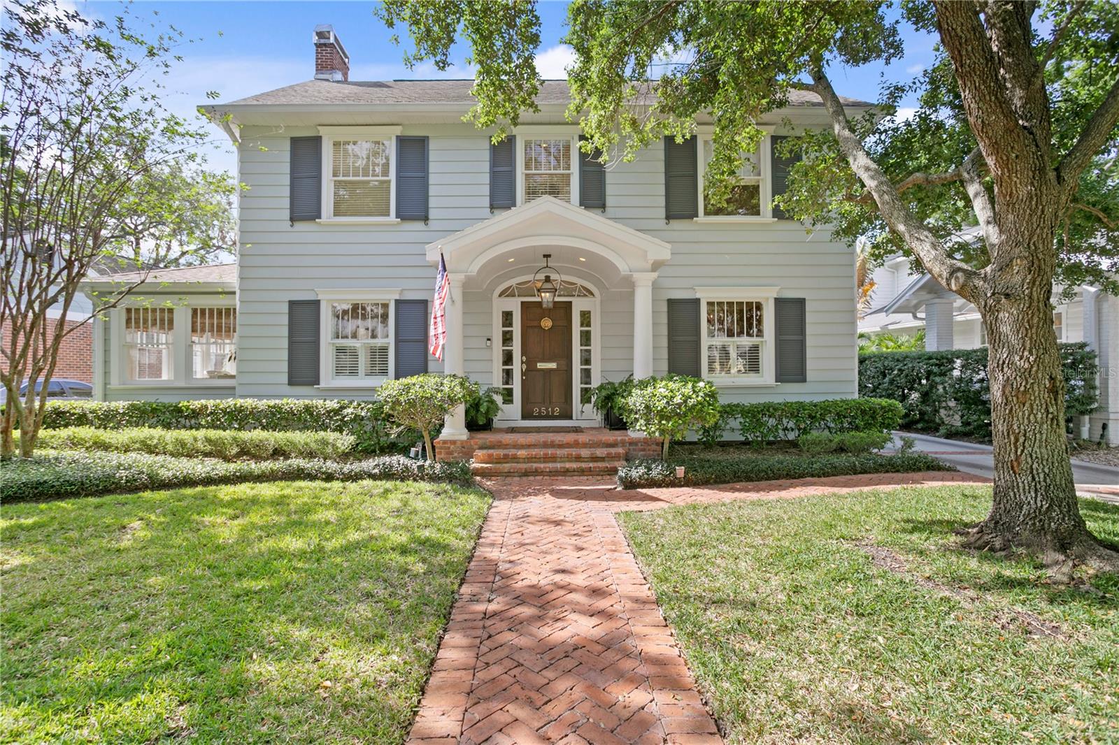 This beautiful and sophisticated 1930’s center hall colonial and guest house is situated on a picturesque tree-lined street in New Suburb Beautiful. With all the charm and history that you love, along with today’s modern touches, this 5 bedrooms and 3.5 baths main home, along with a 1 bedroom, 1 bath guest house with living space and kitchenette, offers ample living space and is perfect for entertaining. A stately foyer centers the large formal dining room and a separate living room with gas fireplace, which leads to a bright and sunny Florida room. The high-end kitchen features Sub Zero appliances, island and a butler’s pantry with wet bar, as well as pantry or storage space and laundry. The spacious family room has a fireplace flanked by beautiful built-ins and Sonos speakers. On the second floor, the large primary bedroom suite (21x17) features beautiful vaulted ceilings, a walk-in closet and en-suite bathroom with double vanity. Four additional bedrooms and two fully renovated full bathrooms complete the second floor. A walk-up finished third floor room serves as a bonus room or storage space. French doors off the family room and a Dutch door off the kitchen lead to a covered brick patio and a spacious, fenced backyard with room for a pool. The detached garage with workshop and additional storage has a second floor with an 832 square foot guest house with a living room, full kitchen, bedroom and bathroom. This stately home has beautiful millwork and new paint and lighting fixtures throughout, a new second floor AC, and a whole-house water filter and softener, along with ample storage. Conveniently located near restaurants, shopping, Hyde Park and Bayshore Boulevard.