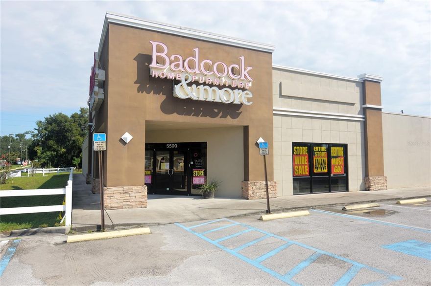 11,900 square feet of air conditioned retail space located in the heart of downtown Zephyrhills flanked on either side by main street thoroughfares with a high traffic count and visibility. Building exterior has undergone a renovation bring into current retail style trends. Building floor plan offers large counter/cashier bar, private office, and 2 restrooms. Also included in the floor plan is a 25'x80' warehouse space with 12' ceilings and a 10'x10' roll up door. Sale includes a total of 3 parcels equaling .96 acres with the option to purchase an adjoining .24 acres with 75' of US301 frontage. Lighted parking lot includes 17 spaces plus 7 additional overflow spaces. Lot has city street frontage on 3 sides and a paved alley access on the 4th side. Very broad and general zoning allows for a wide spectrum of approved uses. New showroom carpeting installed in 2019. Open spacious 95'x112' showroom with 10+ feet high ceilings. Entry includes 2 large display windows and glass door all equipped with retractable steel security curtains.