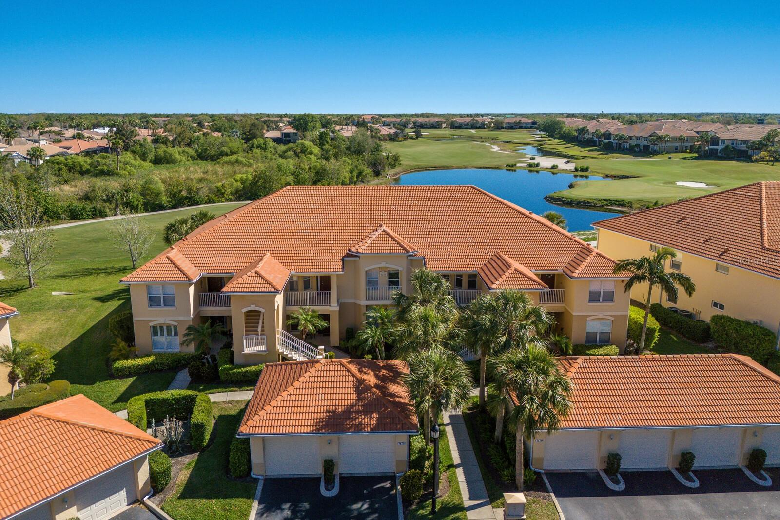 Views like this are a RARE find... especially at this price.... But NOT HERE!! Located in Boca Grove, a quaint condo community tucked away behind the gates of the Lakewood Ranch Golf & Country Club; this residence is exceptionally positioned on the Arnold Palmer designed Legacy Golf Course! Where long views of the 15th Fairway are your daily backdrop, capturing the essence of Florida living... encompassing golf, lake and preserve views, which allow for spectacular native FL wildlife sightings!
This 2/2, second floor unit has been lovingly maintained and updated. Step inside to find soaring ceilings, light-filled rooms & an open-concept floorplan. The updated eat-in kitchen is a delight featuring crisp white cabinetry, stainless appliances & a breakfast bar—perfect for casual dining. Just off the kitchen you'll find the dining and living areas with a rear wall of sliding glass doors that seamlessly blend the indoor elegance with outdoor serenity. Just through the sliders is a spacious screened lanai, currently set up to dine al fresco, enjoy a cup of morning coffee or relax at the end of the day with nice a glass of wine. The Primary suite is a true retreat with tray ceilings, dual walk-in closets, private lanai access and a beautiful en-suite bath complete with updated dual vanity, upgraded fixtures & a spacious walk-in shower. The split floorplan offers ultimate privacy with a 2nd bedroom that also includes a walk-in closet & an updated vanity in the en-suite bath as well! This residence has a calming neutral palette, elegant 20x20 tile flooring on the diagonal & plantation shutters thru-out. Lushly landscaped with the bonus of a 1 car garage... The maintenance-free living leaves nothing to do but ENJOY! The heated community pool/spa & clubhouse offer fantastic opportunities to mingle with friends & neighbors with lovely get togethers, organized by the Boca Grove Social Committee. Boca Grove really is a treasure of only 120 units in the heart of Lakewood Ranch. A golf membership is NOT required, nor is it included... But there are Social, Athletic and Golf memberships available at LWR Golf & CC should you wish to join. The location of Boca Grove is key if you're looking for convenience! It is a mere 5 min drive to LWR Main St, San Marco Plaza, Waterside & the newest CenterPoint Development, where you'll find a plethora of upscale shopping, incredible dining options & year-round entertainment for all! With easy access to I75, UTC, top-notch health care, A-Rated schools & award-winning beaches.. This one truly has it all! NOTE: NEW ROOFS COMING SOON! Special Assessment will be paid in full by Seller, prior to close. Furnishings also available under separate agreement.