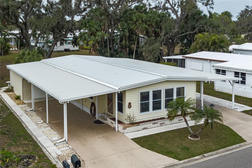 Welcome to Shadowbrook, a highly desirable non-age-restricted land-owned community offering comfort, convenience, and exceptional value. This spacious 2-bedroom, 2-bath home boasts over 1,400 square feet of thoughtfully designed living space and is packed with impressive upgrades. Enjoy the rare benefit of not one, but two separate new carports—perfect for extra vehicles or golf carts—along with a new HVAC system, new electrical in the oversized shed, screen room replacement, newer windows, and a new metal roof-over replacement for added peace of mind. Inside, New luxury vinyl flooring, carpet and tile flow beautifully throughout the home, complementing the generous layout that includes a large Florida room ideal for relaxing or entertaining year-round. The low condo fee provides outstanding value and includes access to the community pool and clubhouse, as well as water, sewer, internet, cable, and more. Located in a non-flood zone, this property offers additional security and savings. The backyard is a true retreat, surrounded by a verdant forest of trees that creates a peaceful, private backdrop—perfect for hosting backyard barbecues or simply unwinding with a good book. Conveniently located near Virgil Mills Elementary School, Buffalo Creek Middle School, and Parrish Community High School, the home is also just a short drive to the stunning beaches of Anna Maria Island, the natural beauty of Terra Ceia Preserve State Park, and the iconic Sunshine Skyway Bridge. With easy access to Interstate 75 and close proximity to a variety of restaurants and shopping destinations, this home truly offers the best of Florida living.