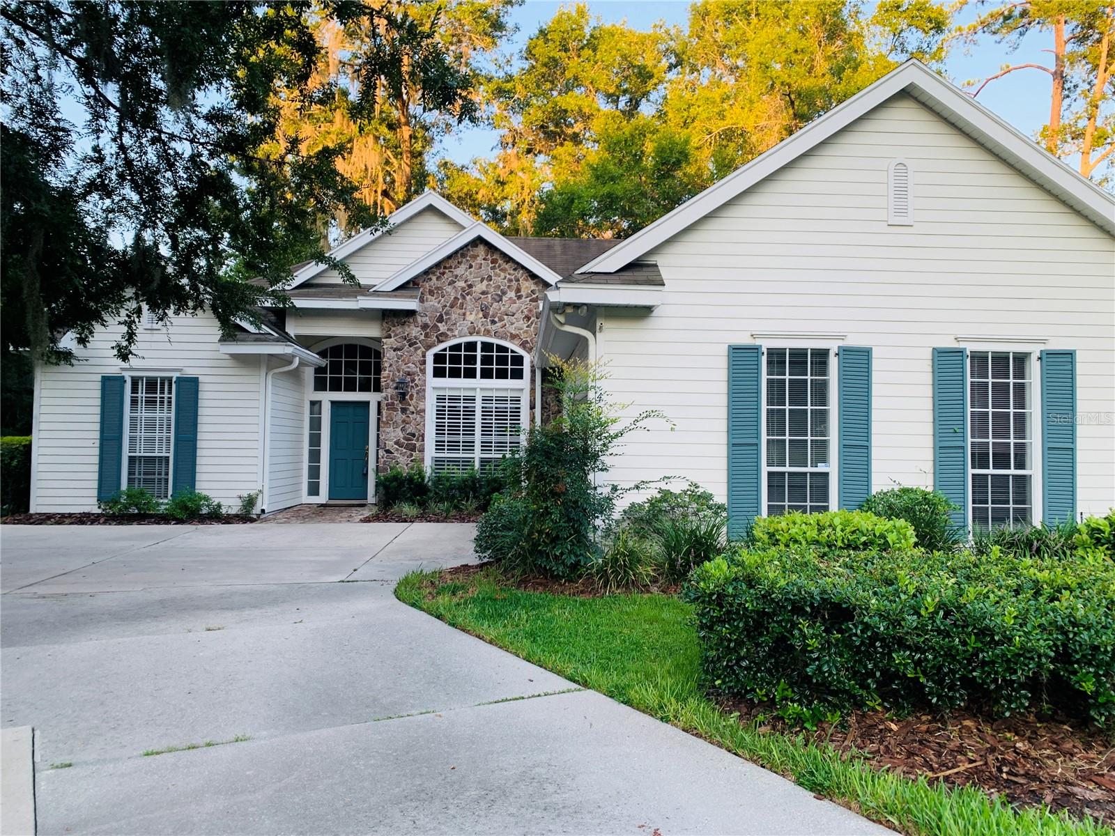 Welcome to this charming 3 bedroom, 2 bath home located in the highly sought-after Hampstead Park neighborhood of Haile Plantation. With soaring ceilings throughout and an abundance of natural light, this home feels open, warm, and inviting. The spacious great room features brand new wood flooring, a cozy fireplace, and flows seamlessly into the dining spaces. Enjoy casual meals at the breakfast bar or nook overlooking the backyard, and host dinner parties in the formal dining room with its front-facing view. The master suite is a private retreat, complete with French doors leading to the back deck, a generous walk-in closet, dual vanities, a walk-in shower, and a jacuzzi tub for ultimate relaxation. On the opposite side of the home, you’ll find two comfortable guest bedrooms and a full bath. Step outside to a fully fenced backyard with a wood deck, screened lanai, and plenty of room for play. Perfectly located close to the Hampstead Park Playground and Hawkstone Country Club, this home offers both convenience and community. Living in Haile Plantation means enjoying an unparalleled lifestyle, with over 15 miles of scenic walking trails and the vibrant Haile Village Center offers shops, dining, and a beloved weekly farmers market. Join the Hawkstone country club and have access to their golf course, three swimming pools, tennis and pickleball courts, and fitness center.